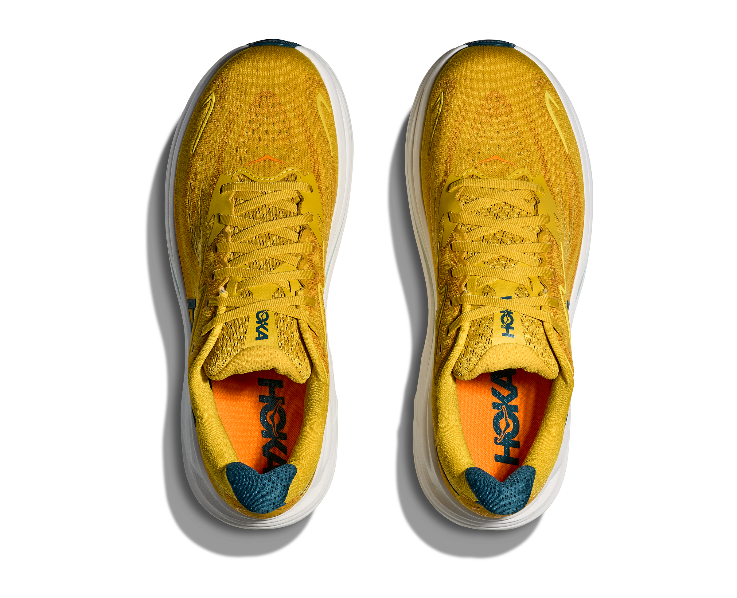 Yellow running shoes with orange accents on a white background