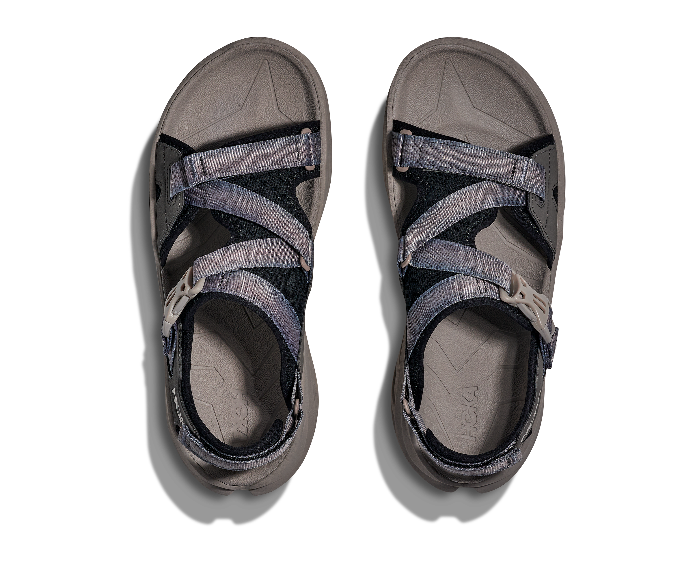 Pair of gray sandals with multiple straps on a white background