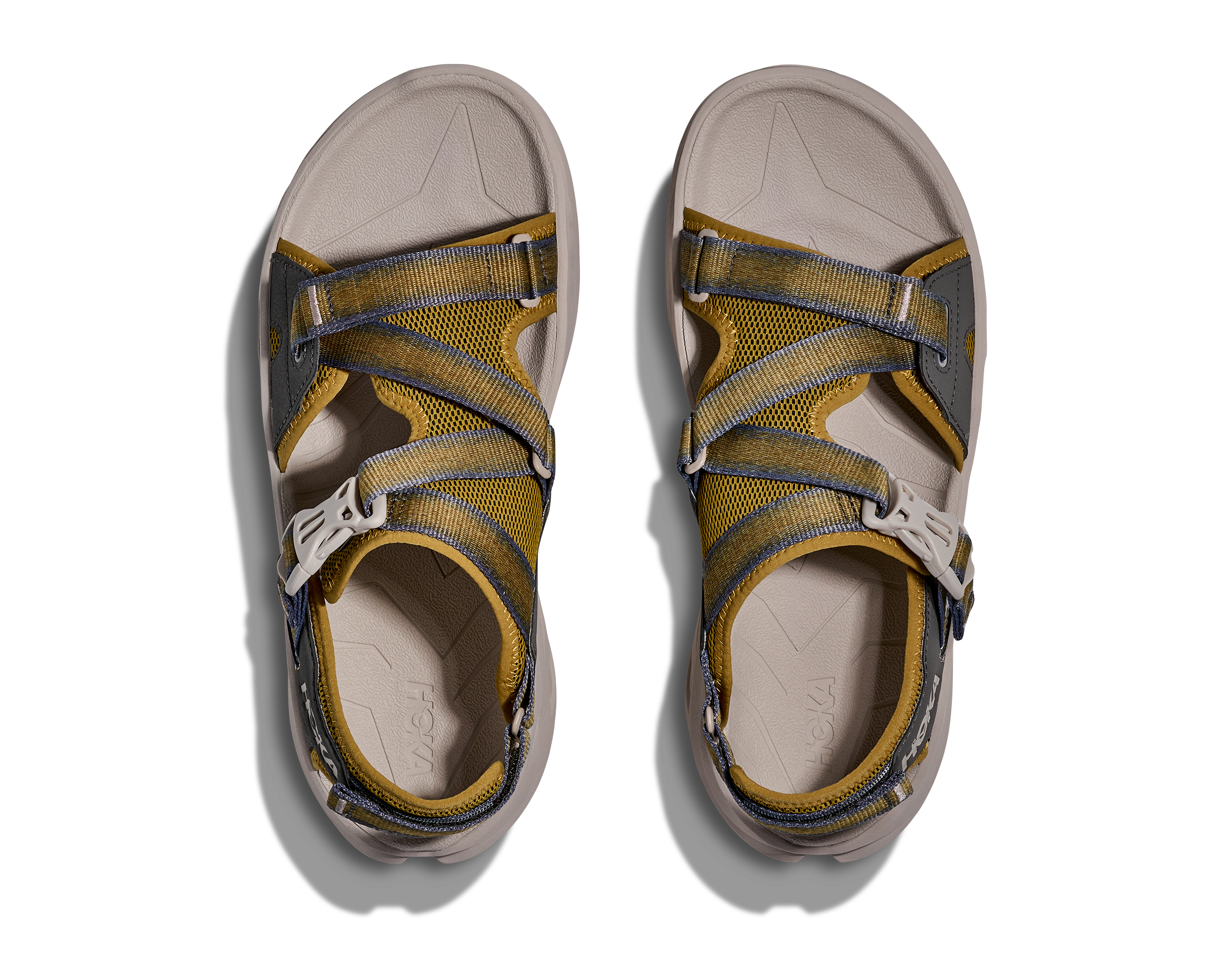 Pair of yellow and gray sandals on a white background