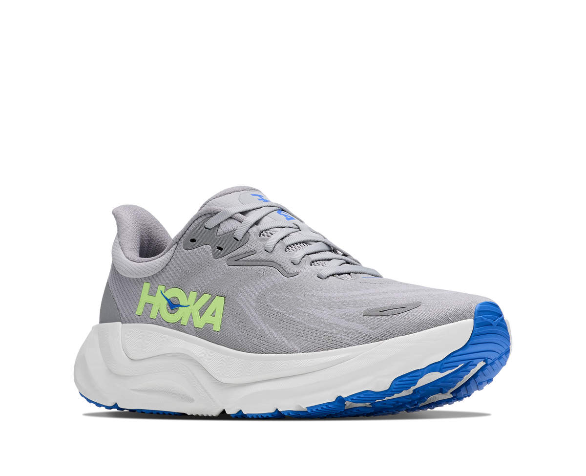 Gray running shoe with blue sole and green 'Hoka' logo on a white background