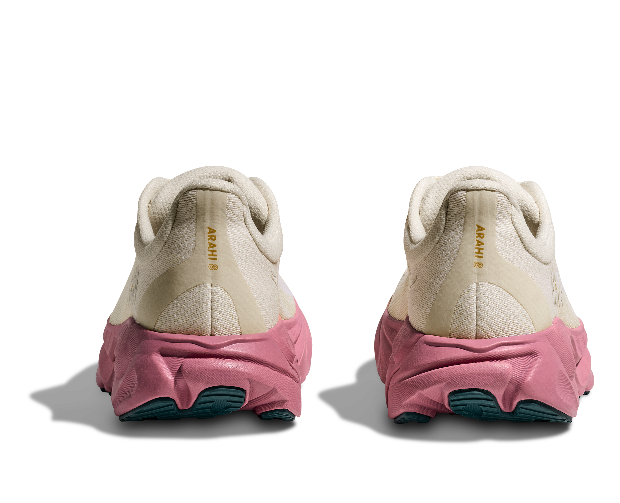 Pair of white sneakers with pink soles on a transparent background
