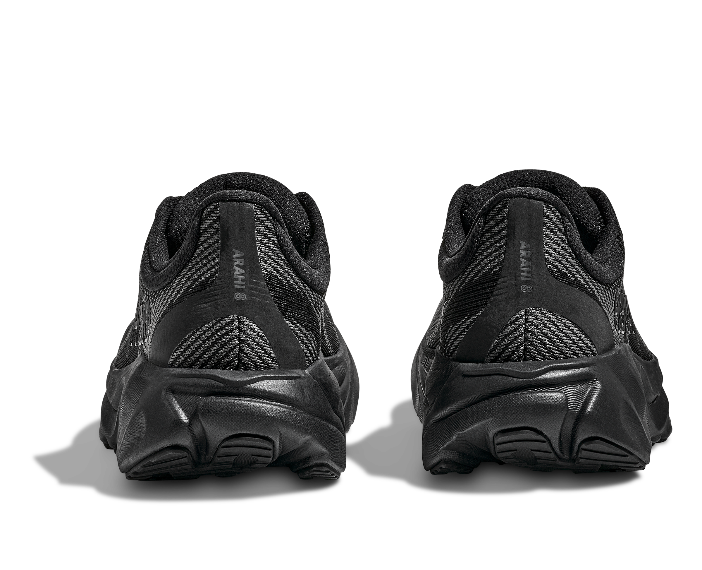 Black running shoes shown from the back on a white background