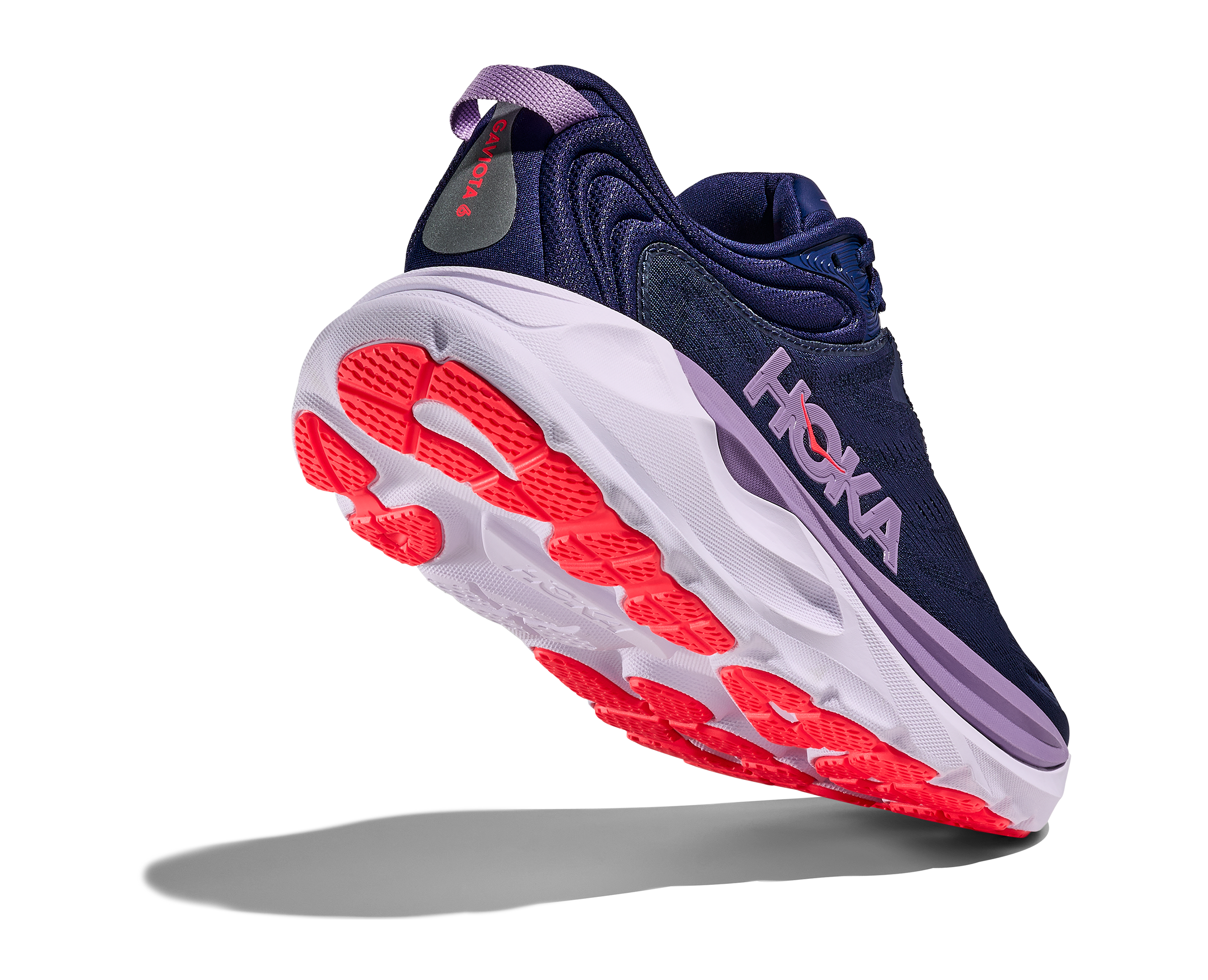 Navy running shoe with red sole on a white background