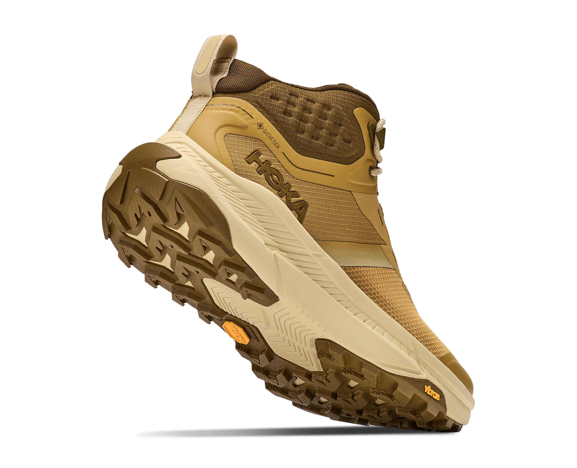 A Hoka mid-height hiking boot in tan and brown, shown at a three-quarter angle against a plain white background.