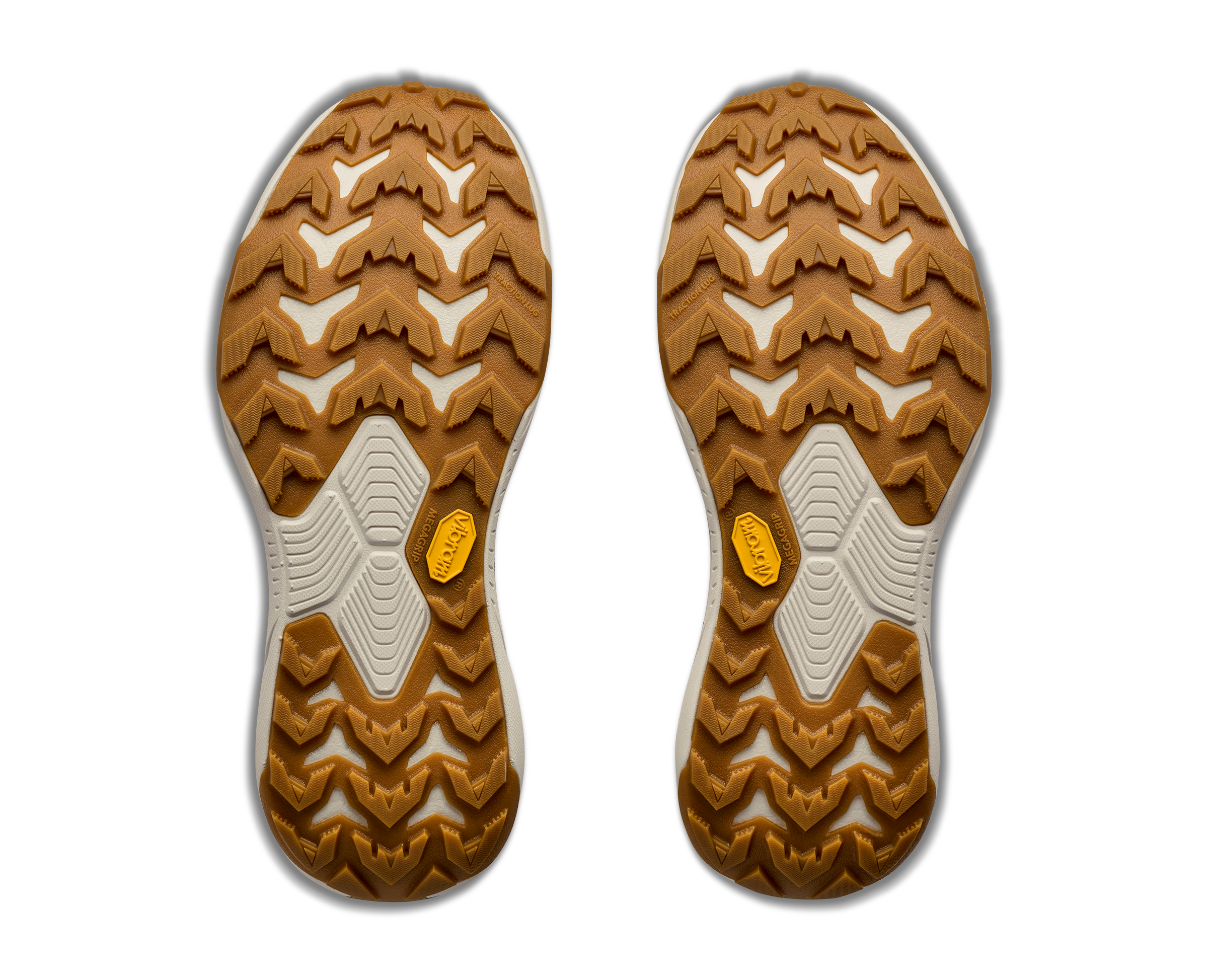 Close-up of a pair of brown shoe soles with tread pattern on a white background