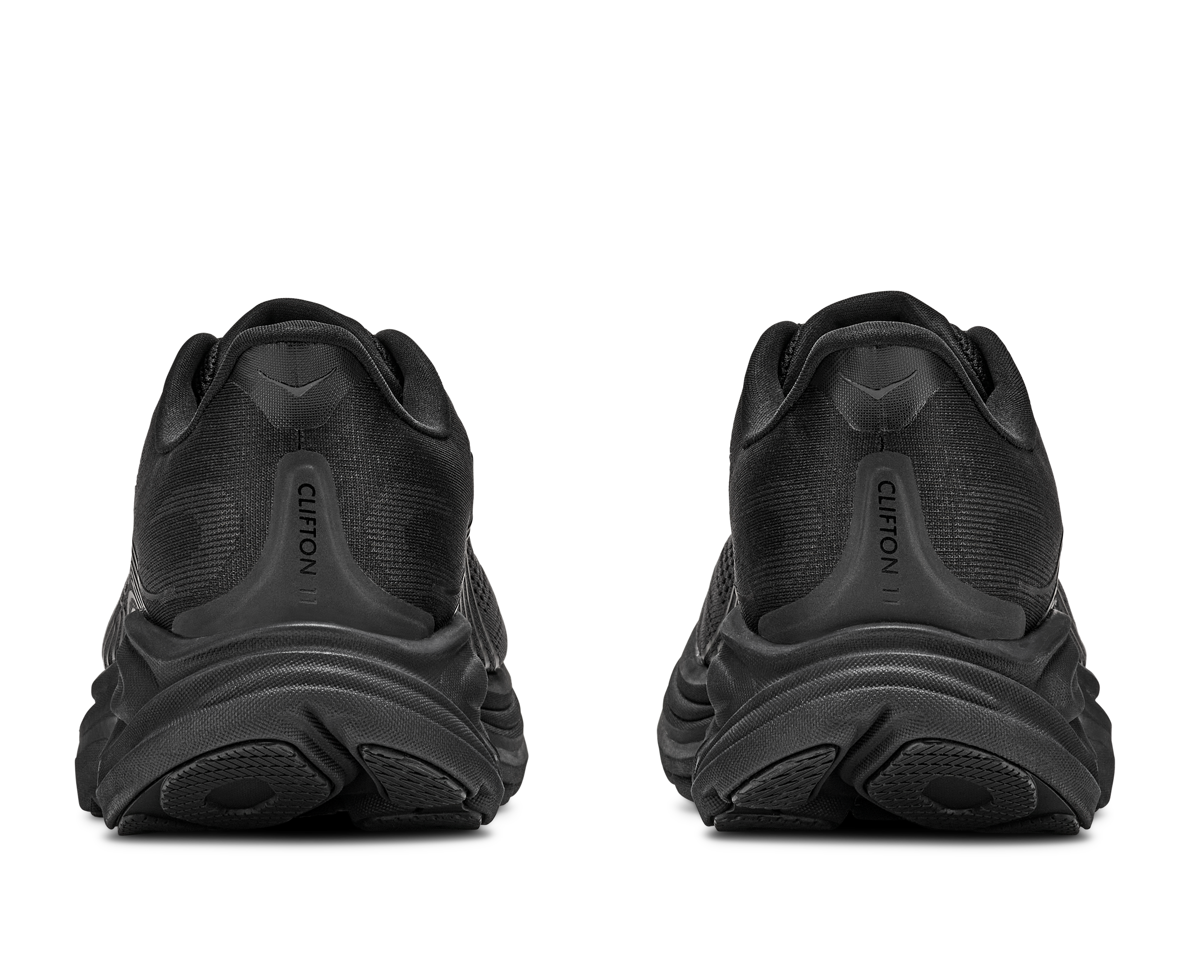 Black athletic shoes with 'Hoka' branding on a white background