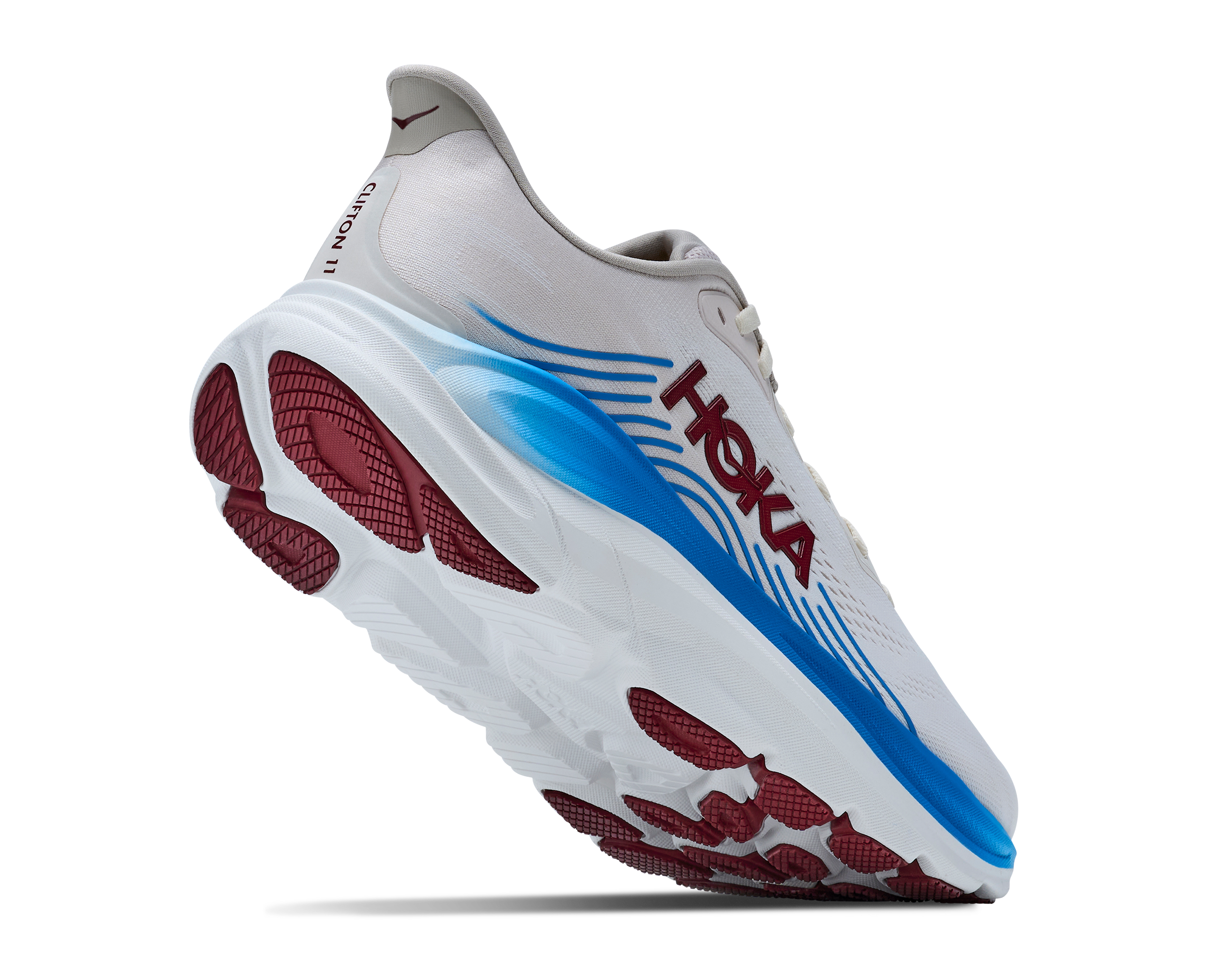 White running shoe with blue and red sole on a white background