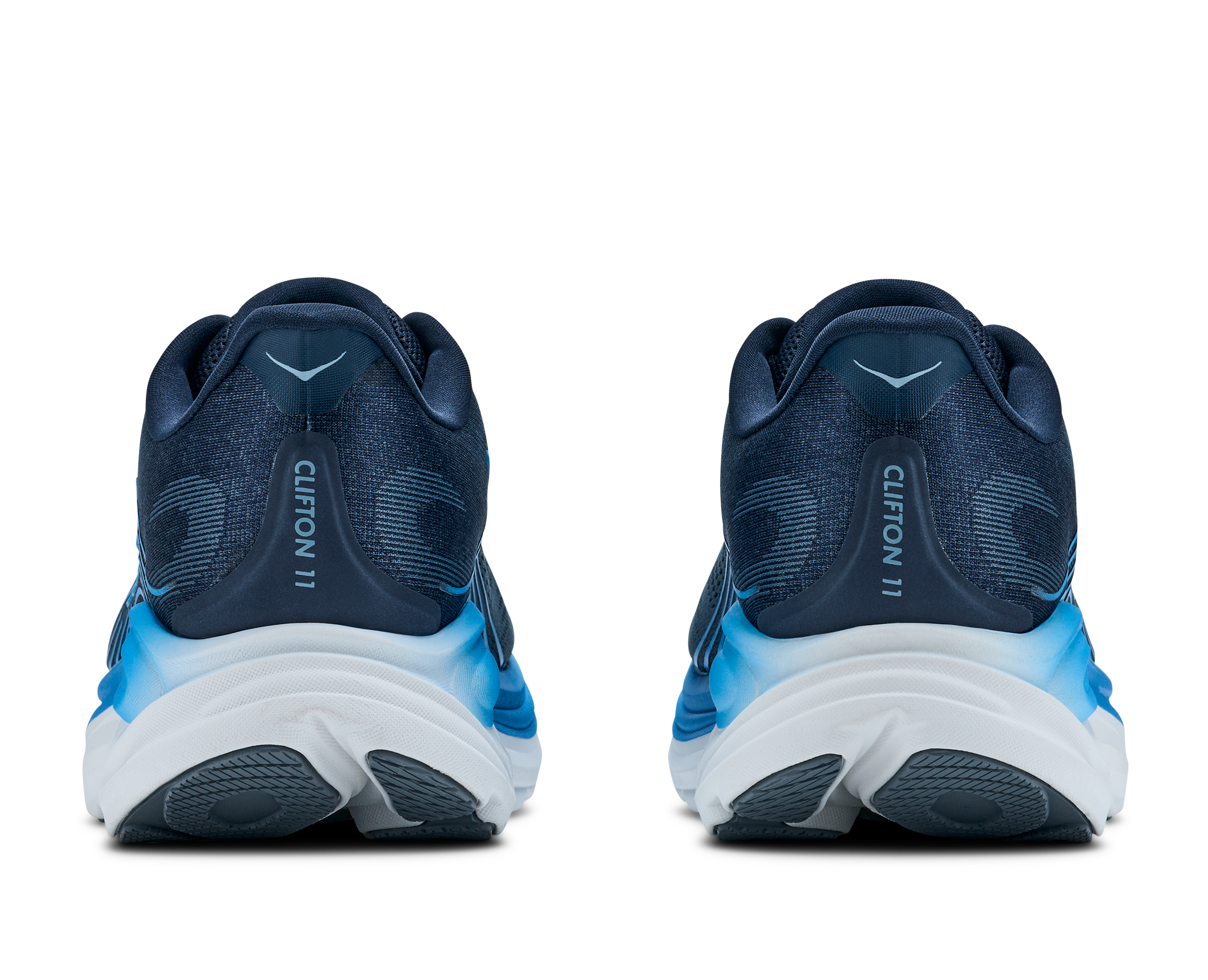 Pair of navy running shoes with white soles on a transparent background