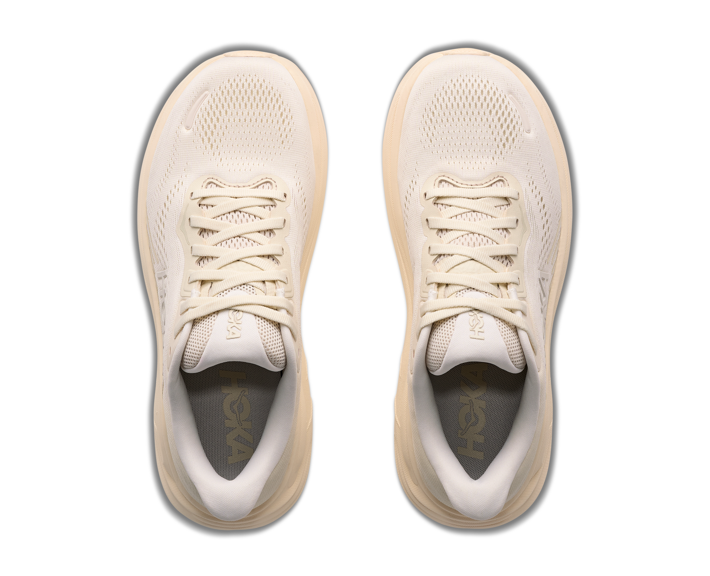 Pair of beige running shoes on a white background