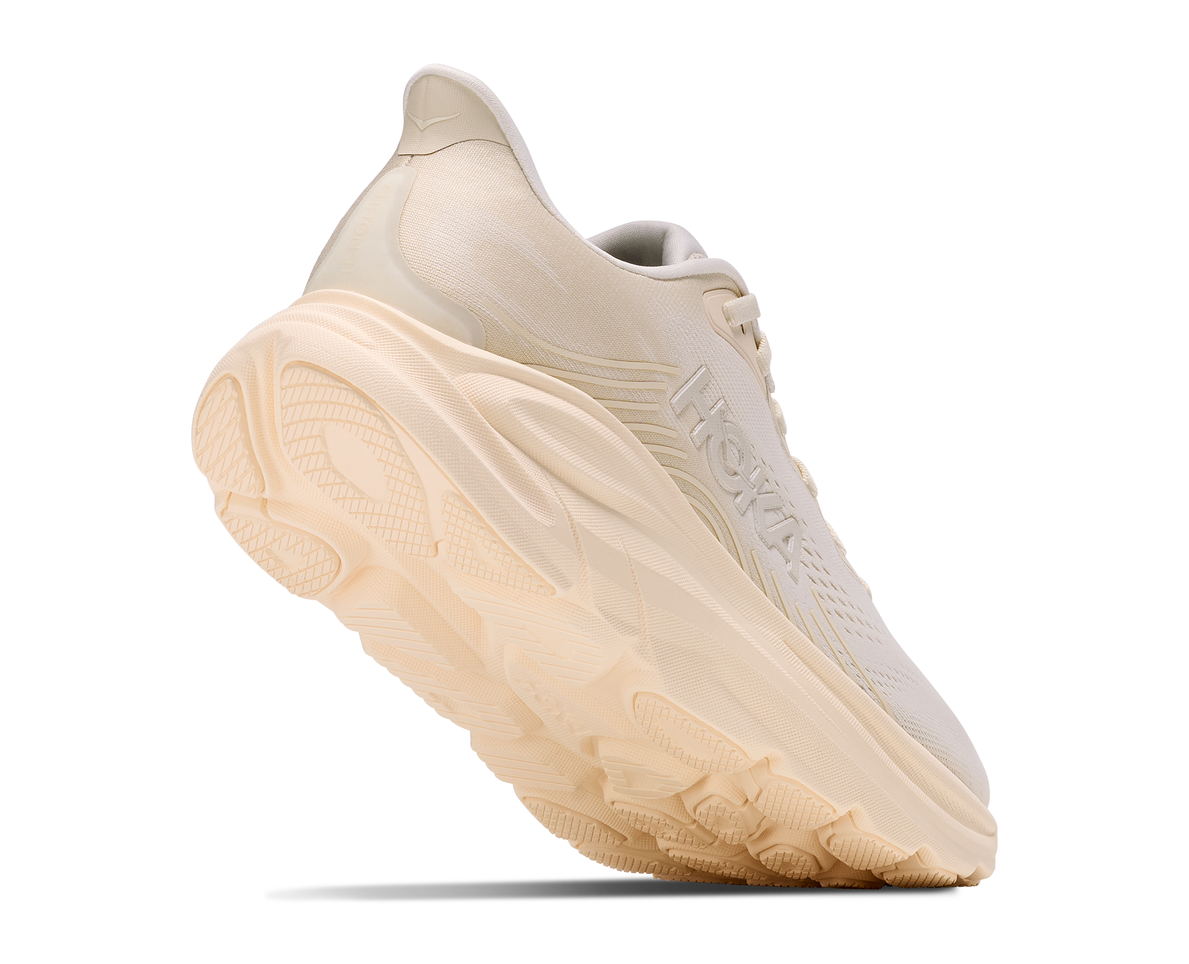 Beige running shoe with a thick sole on a white background