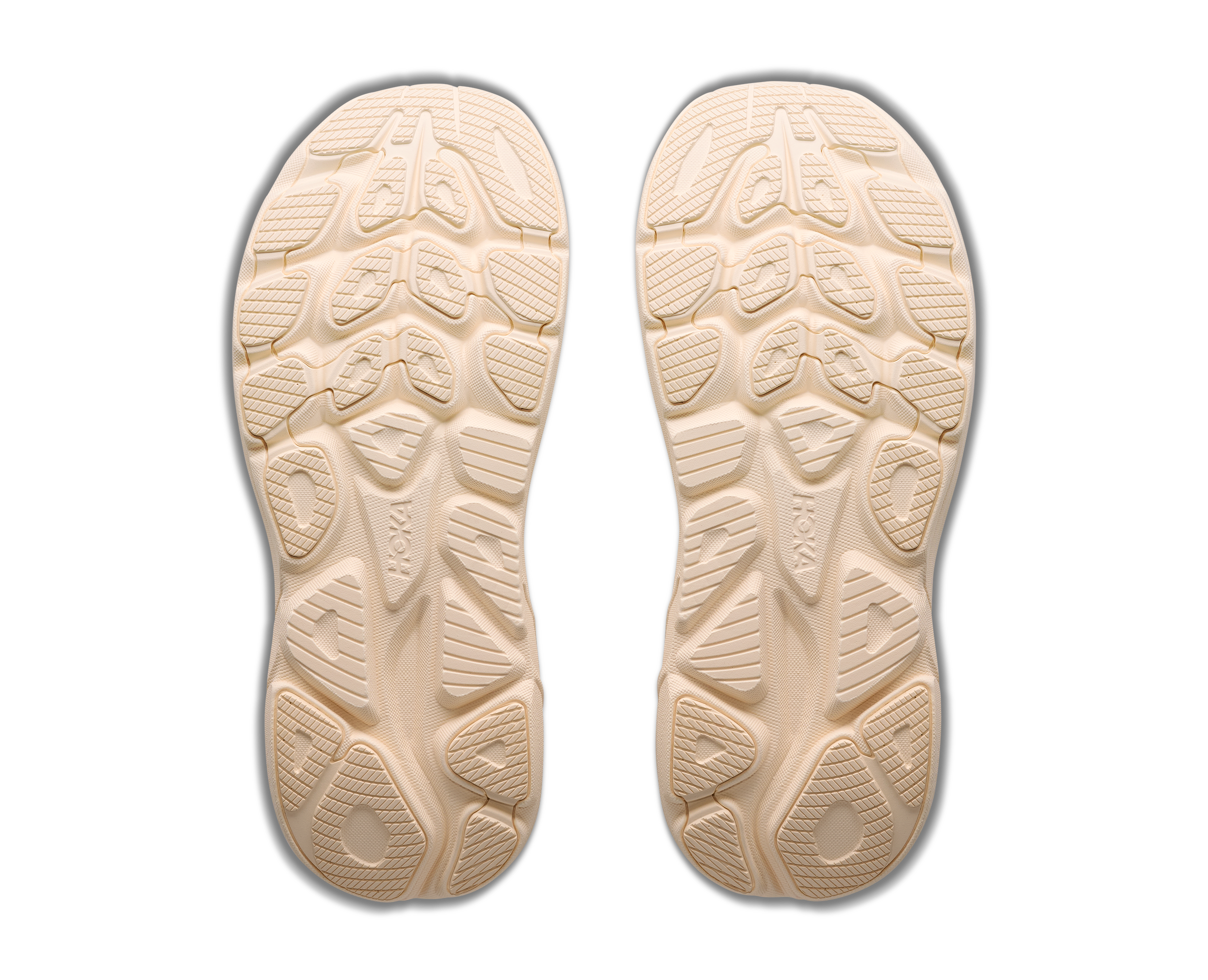 Beige shoe insoles with tread pattern on a white background