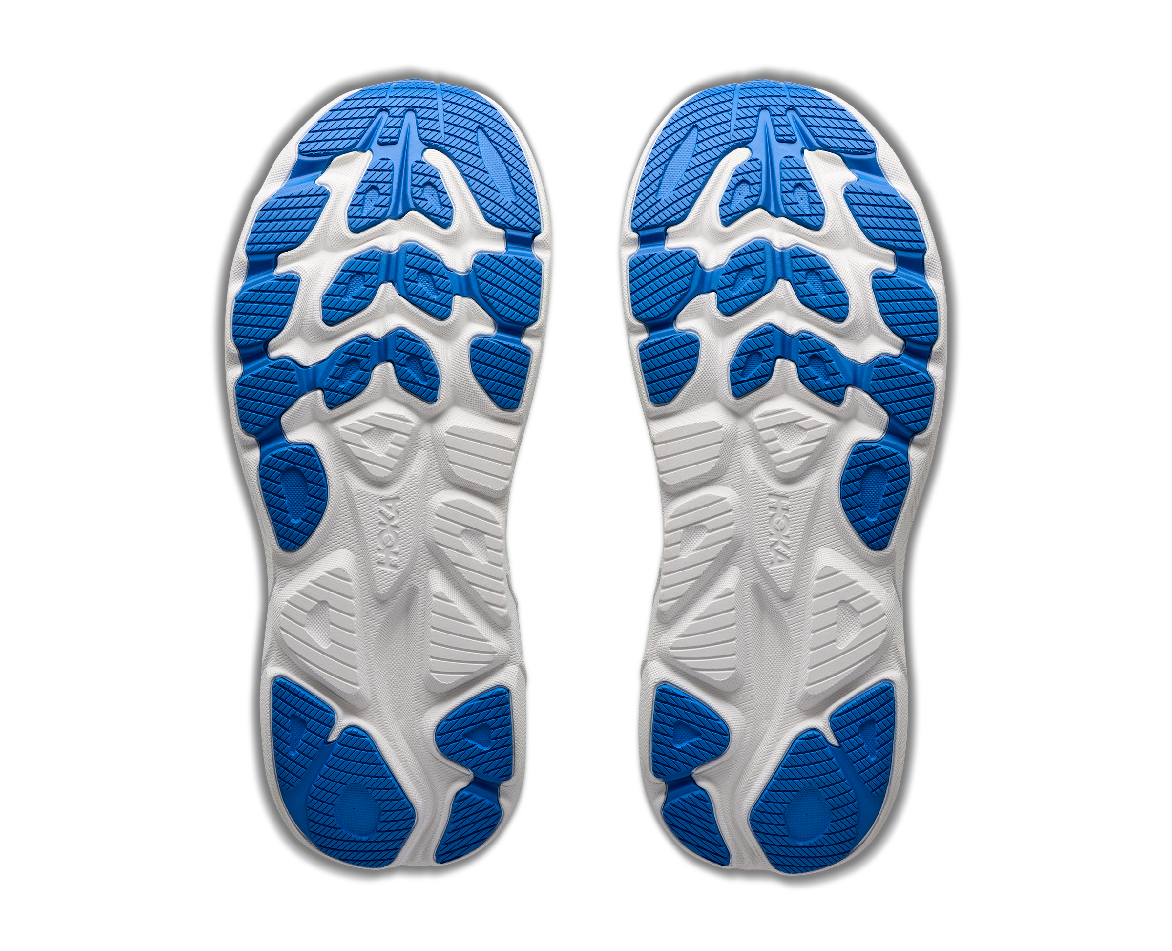 White athletic shoes with blue soles on a white background