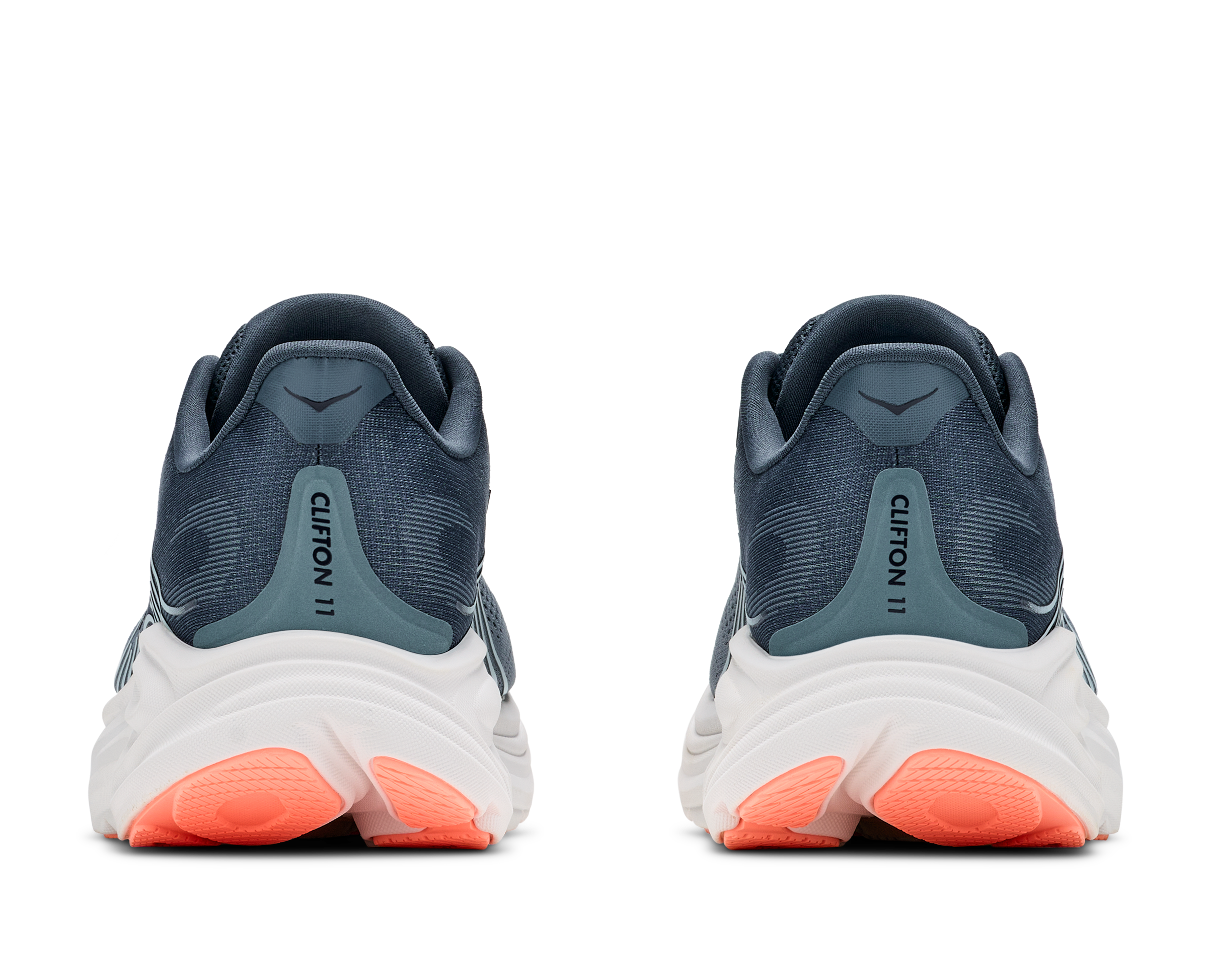 Pair of running shoes with a white sole and orange accents on a transparent background