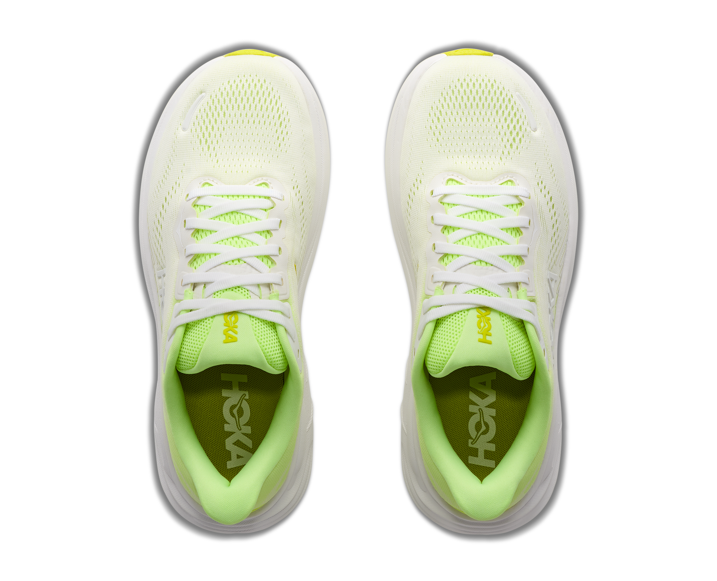 Pair of neon green and white running shoes on a white background