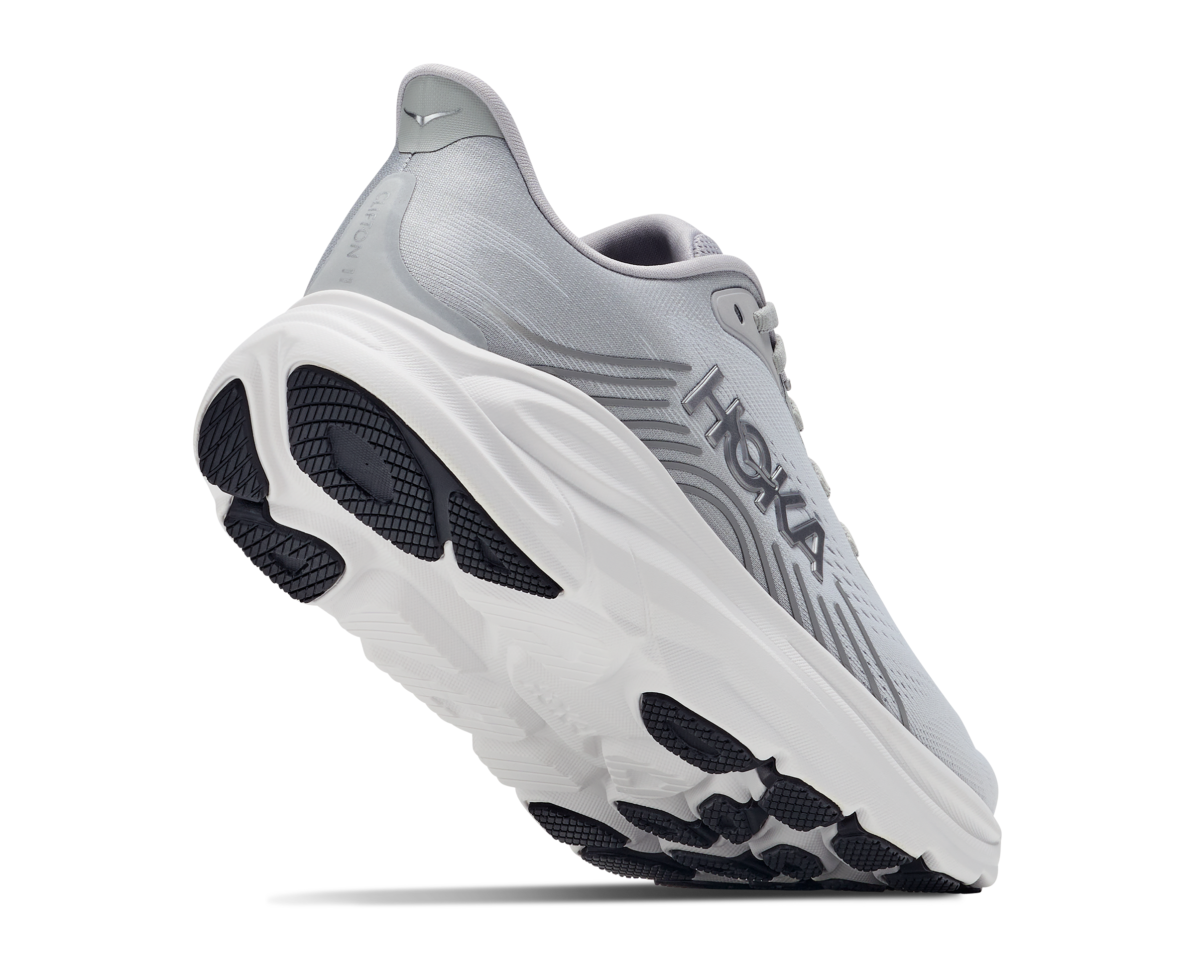 A Hoka running shoe in light gray and white with black outsole details, shown from a three-quarters angle on a white background.
