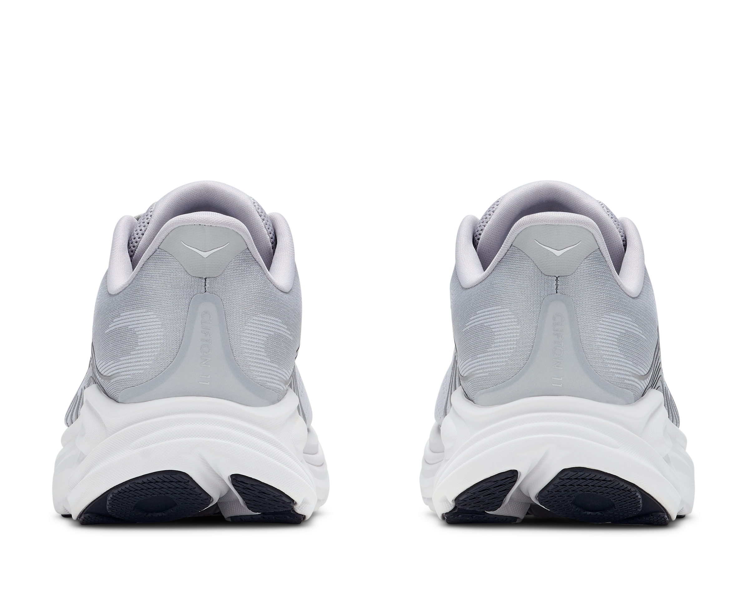 Pair of gray running shoes with white soles on a white background