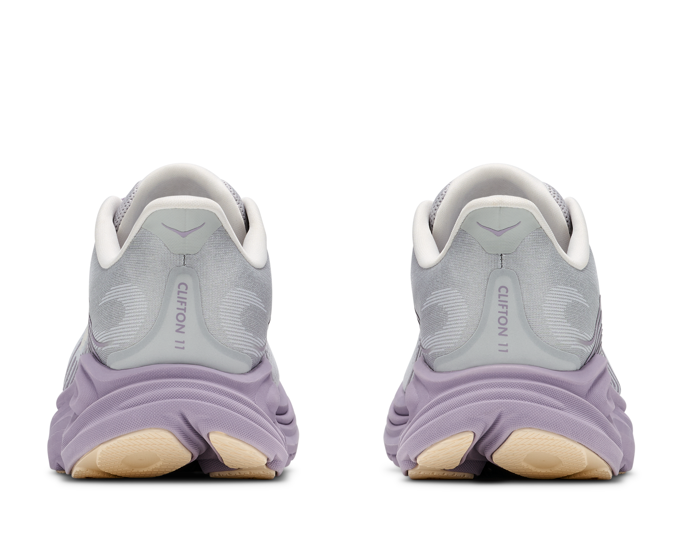 Pair of gray running shoes with purple soles on a white background