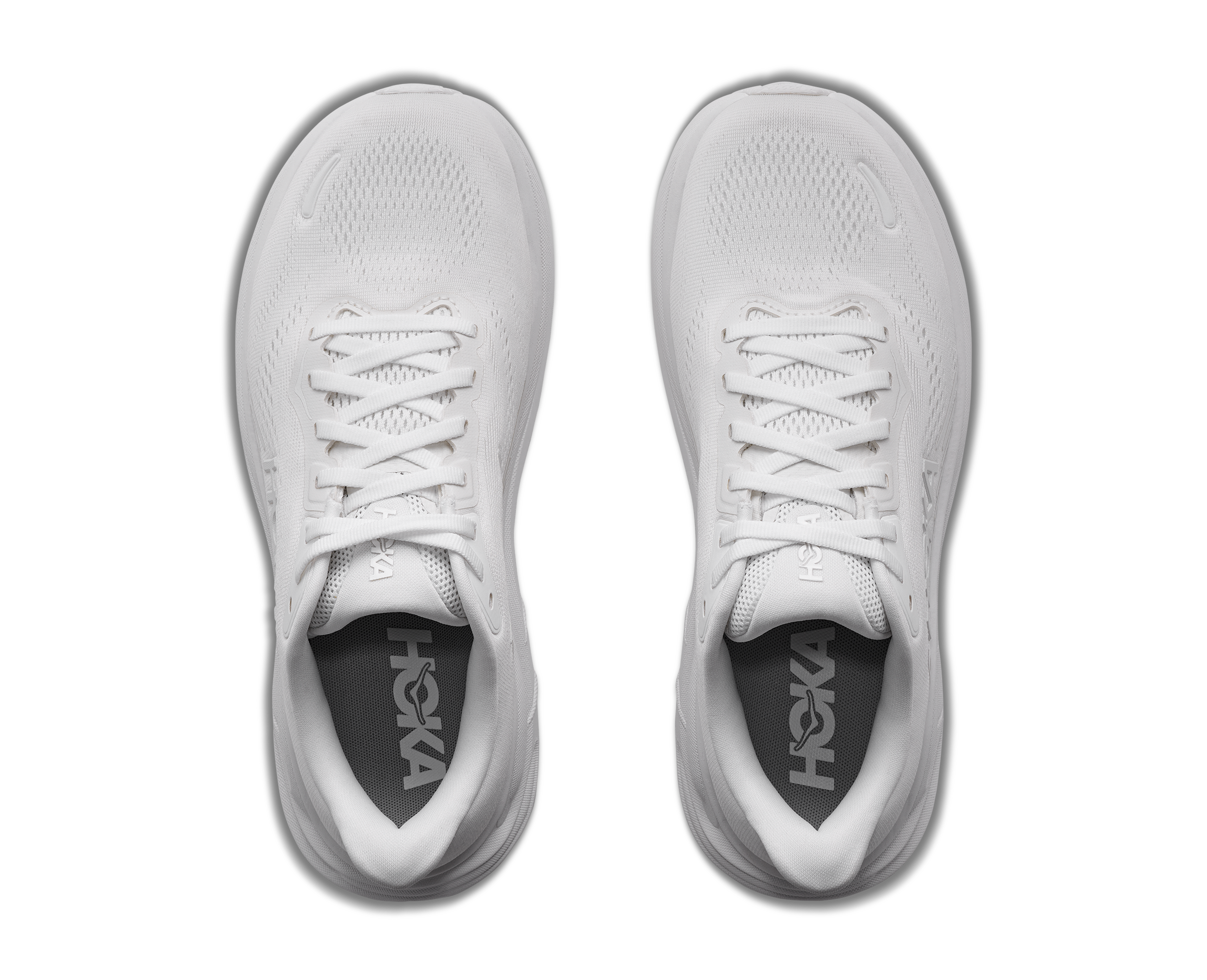 White running shoes with 'Hoka' branding on a white background