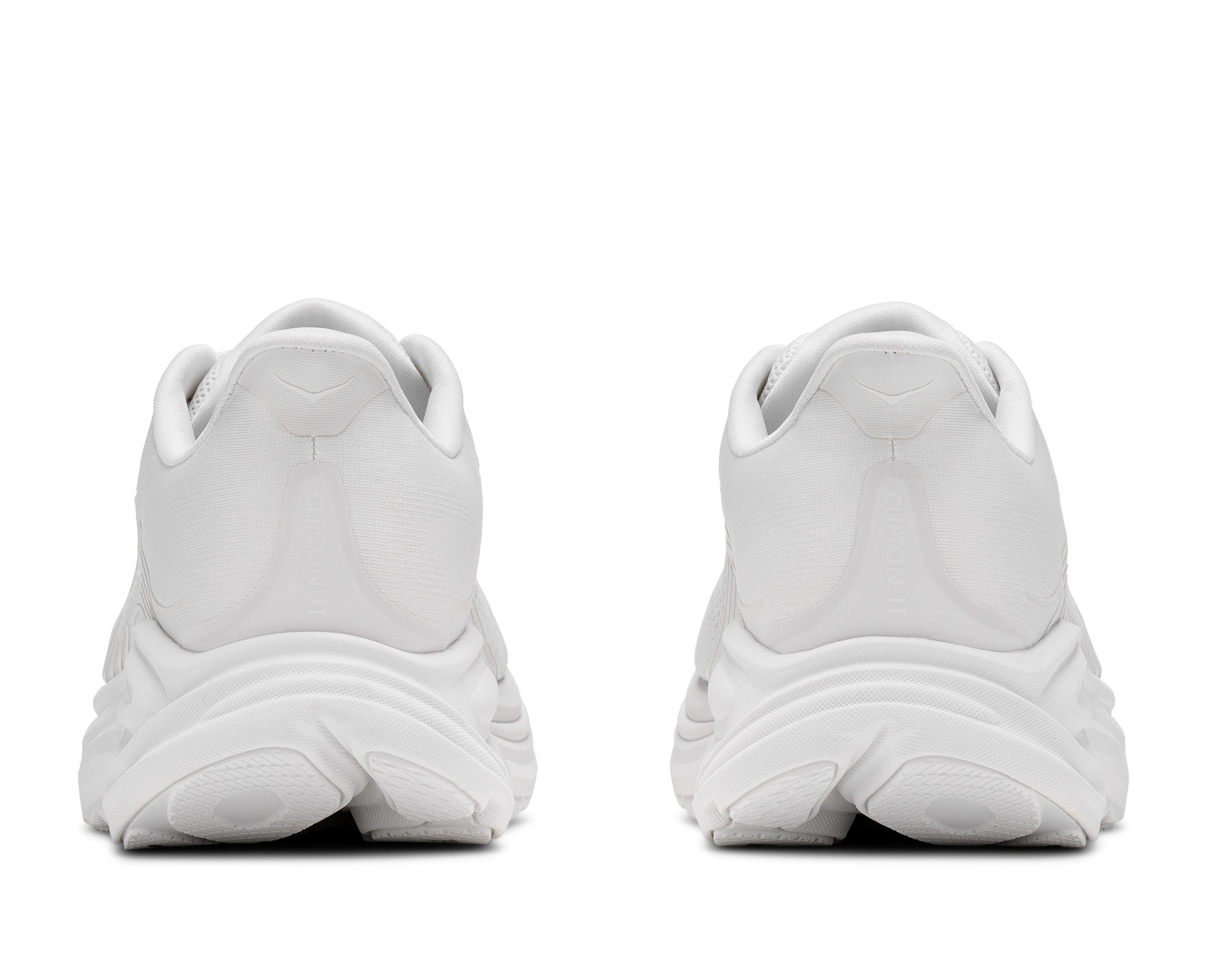 White athletic shoes shown from the back on a white background