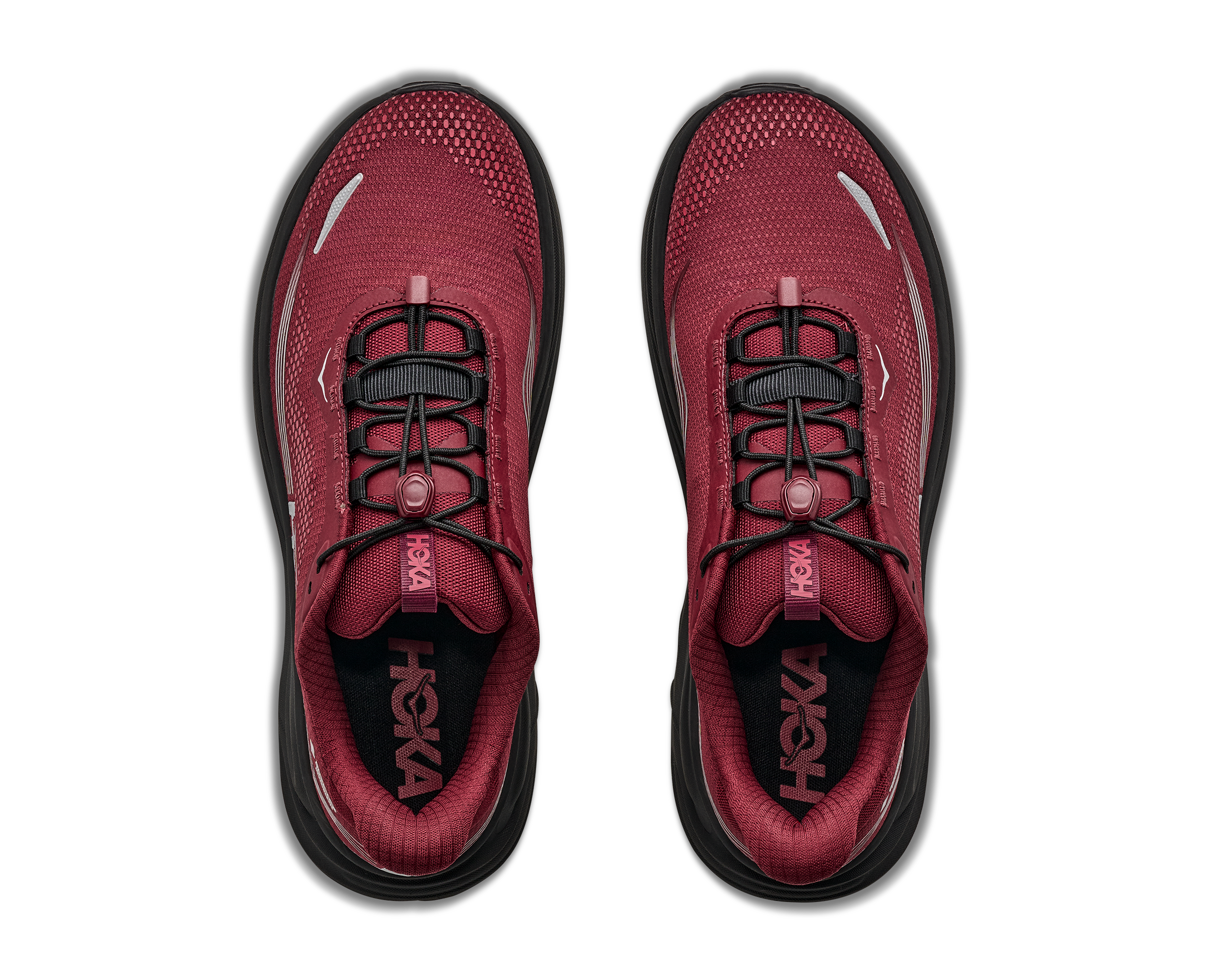 Red running shoes with black soles on a white background