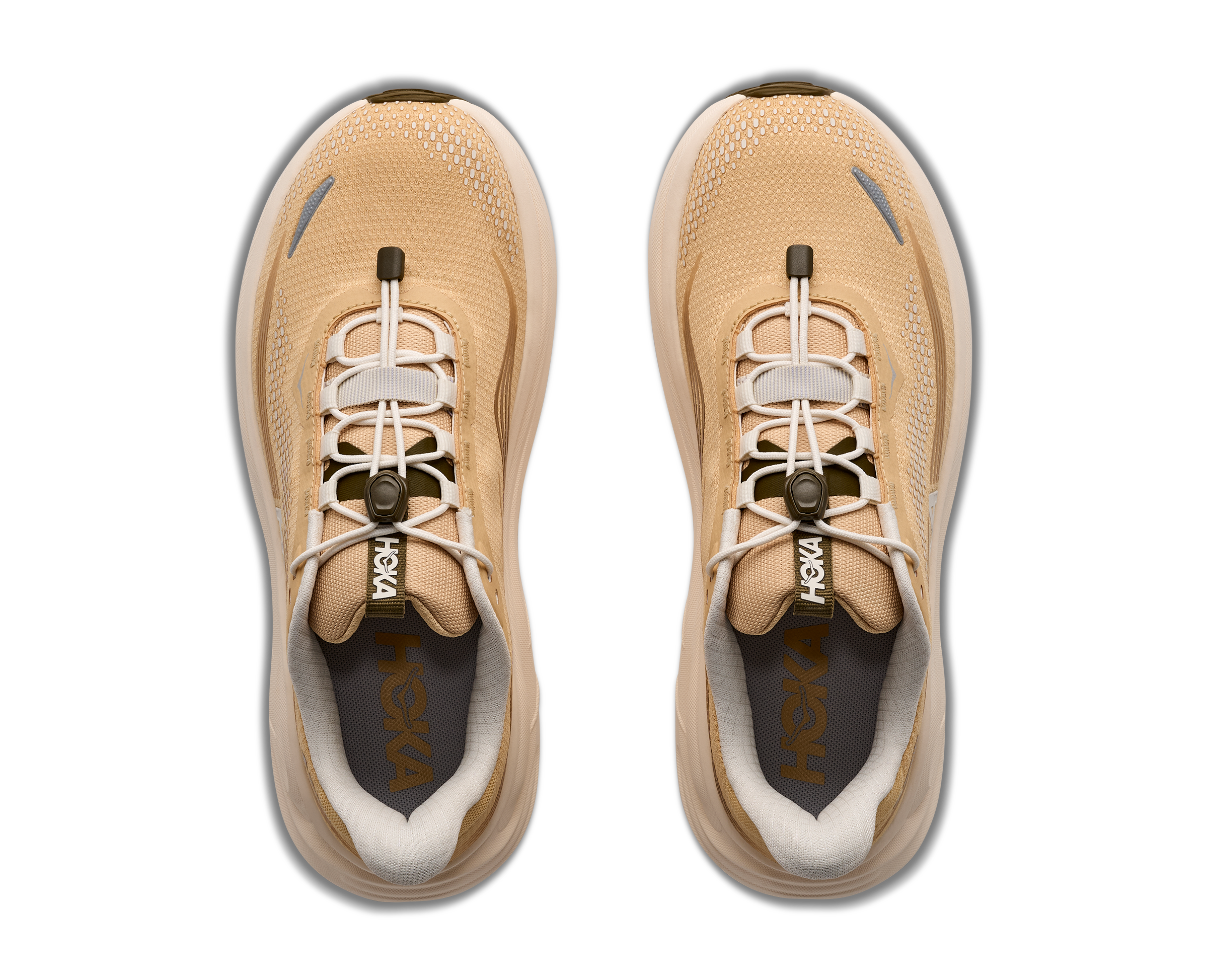 Pair of tan running shoes with white soles on a white background
