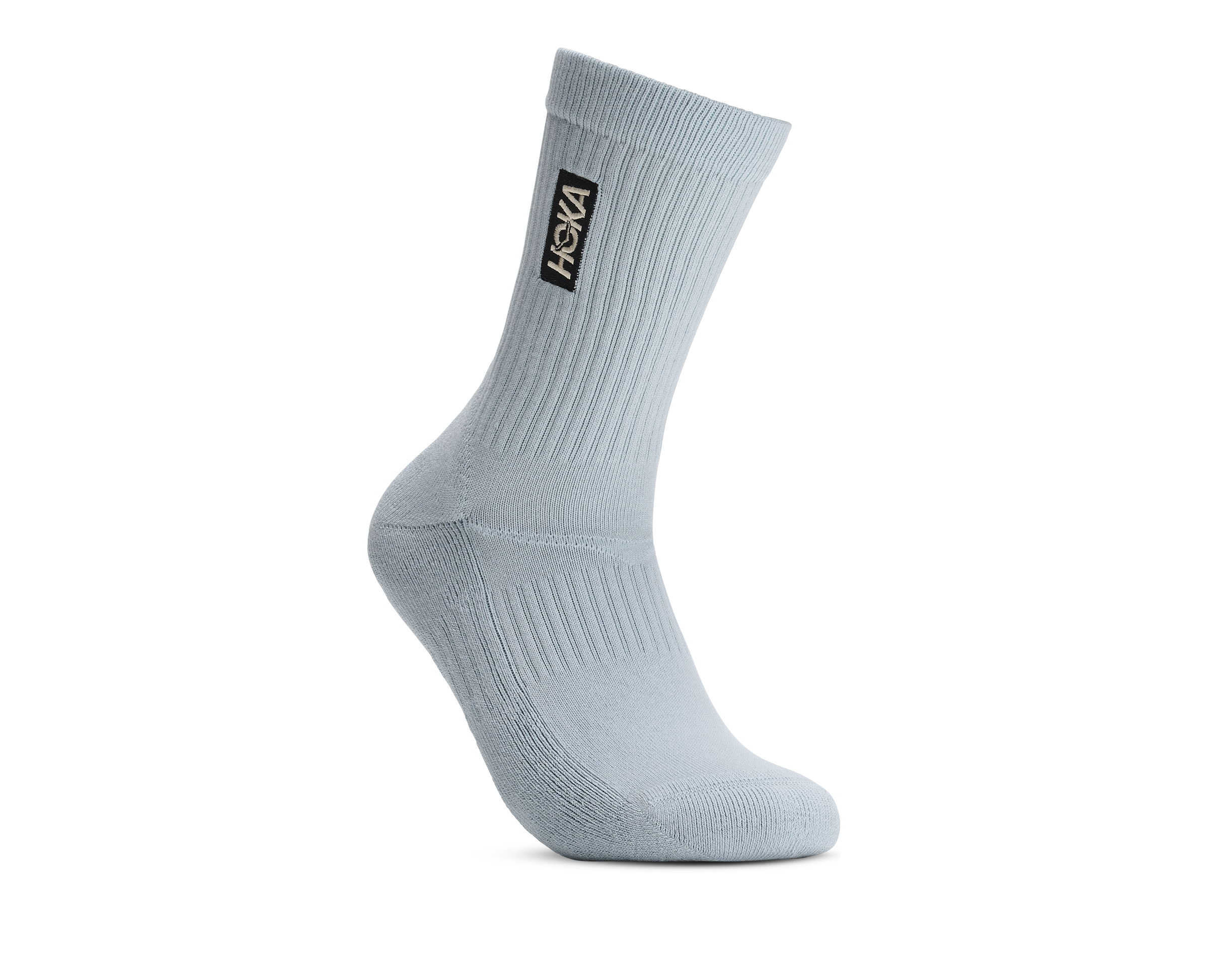 A single light blue crew sock shown from a side profile on a clean white background, featuring a black and gold Vans logo patch on the ribbed ankle cuff.