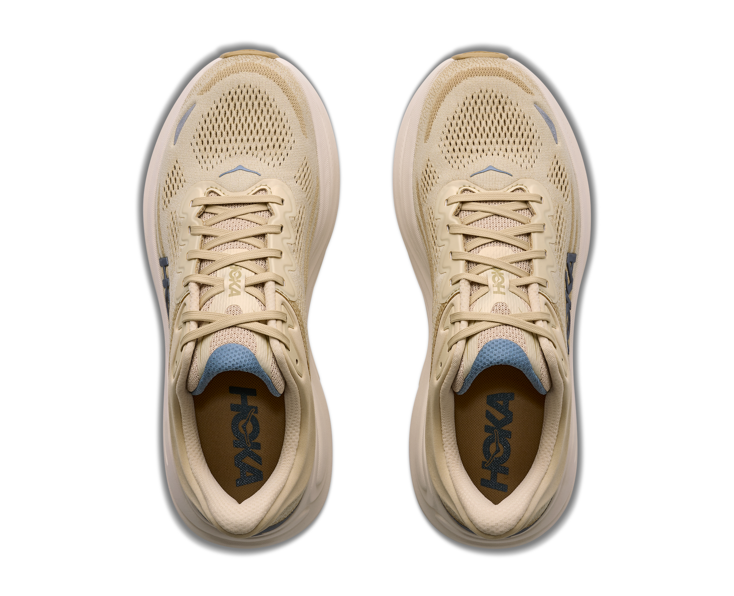 Pair of beige running shoes with blue accents on a white background