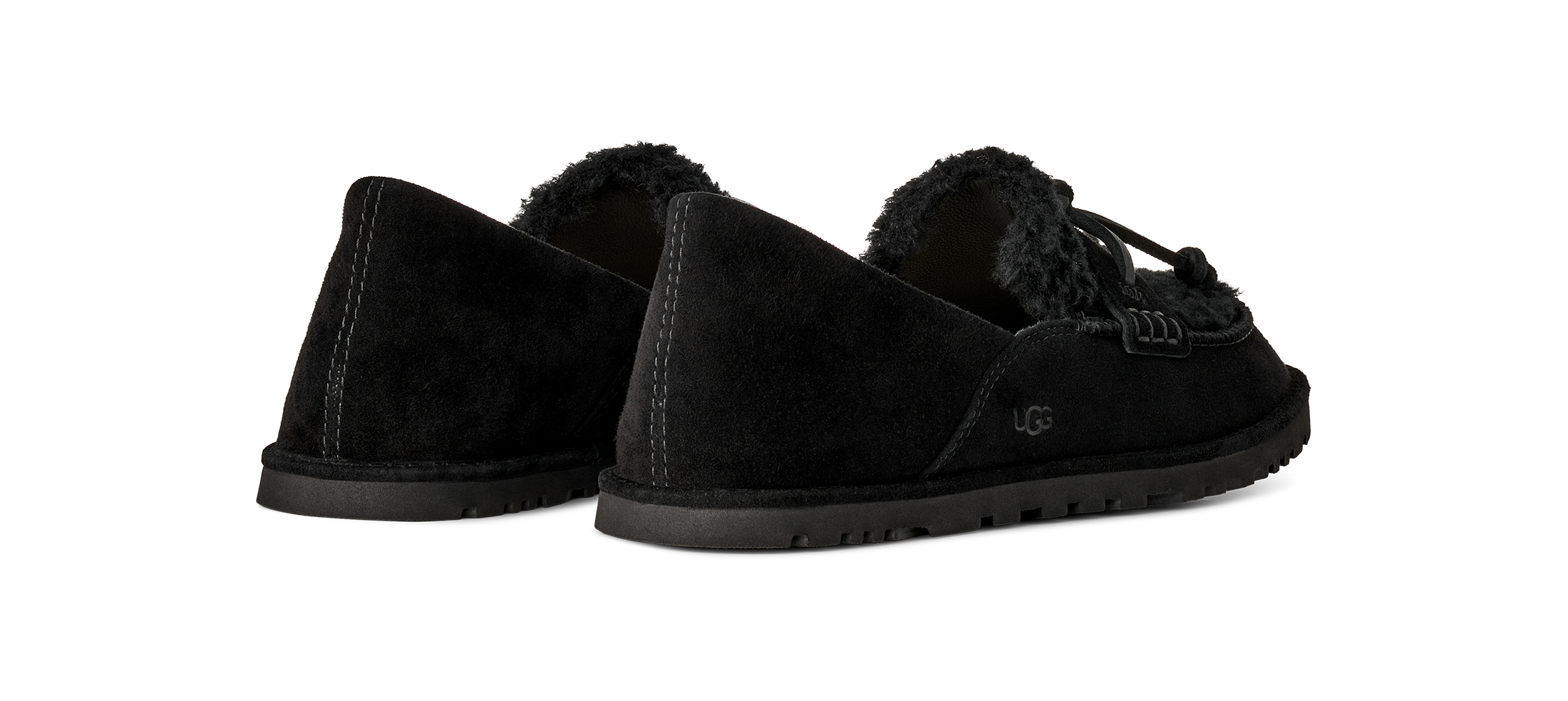 A pair of black suede slip-on slippers with black soles and a black faux-fur lining, shown from the side against a plain white background.