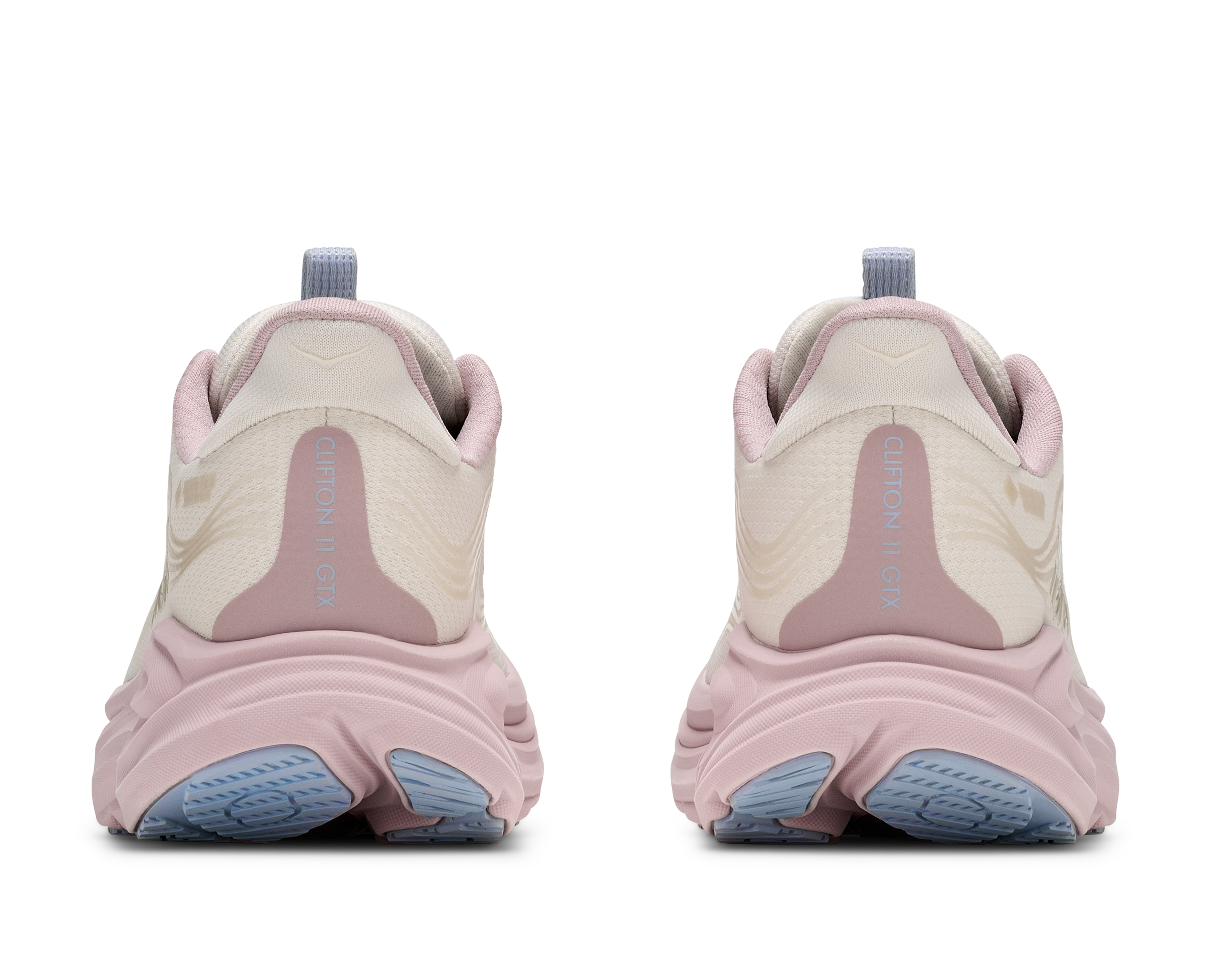 Pair of pink and beige sneakers with blue soles on a white background