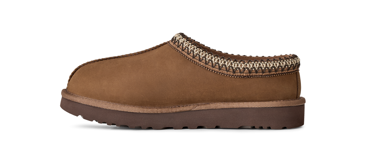 A single brown suede slipper shoe with a braided trim around the collar and a dark brown sole, shown in profile against a white background.