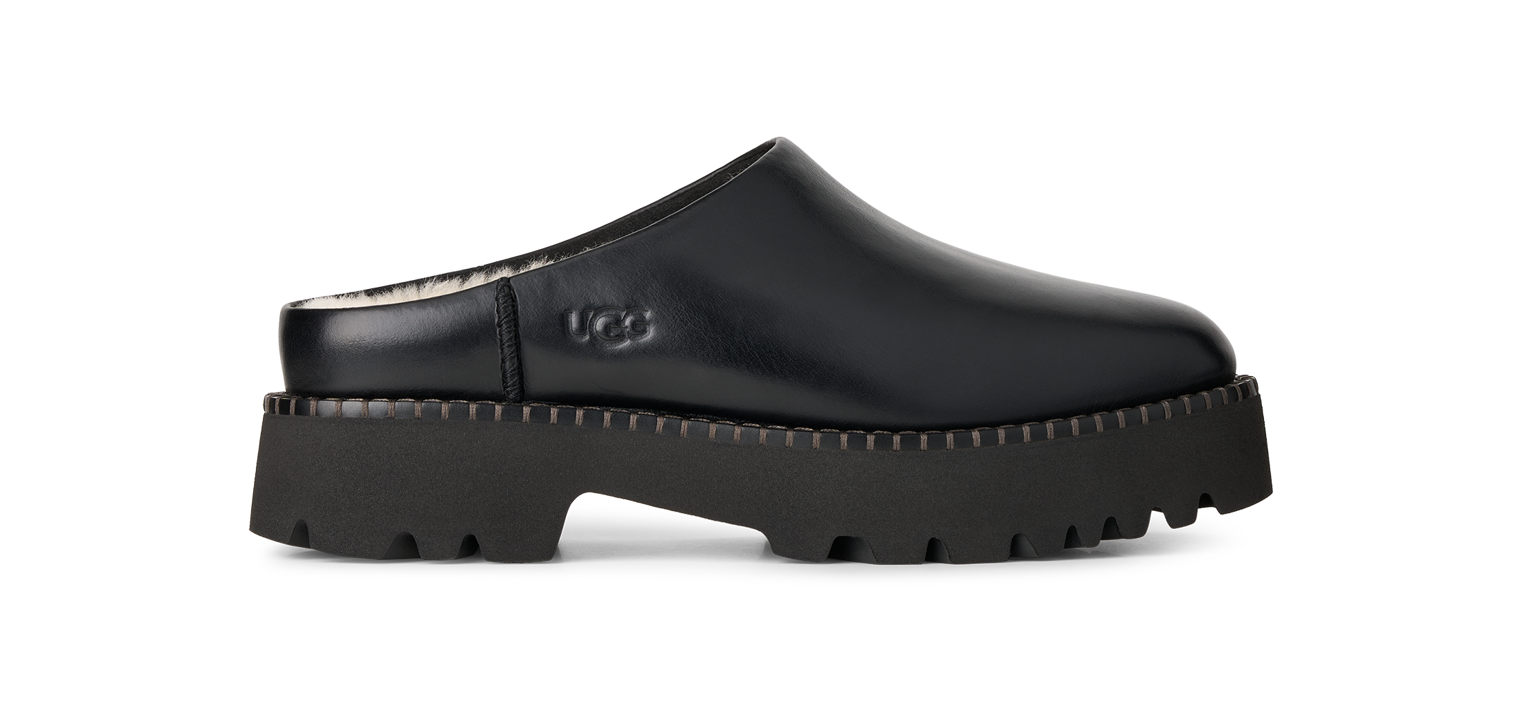 A black leather clog shoe with a chunky lug sole, shown in a side profile on a white background. The UGG logo is embossed on the side of the shoe.