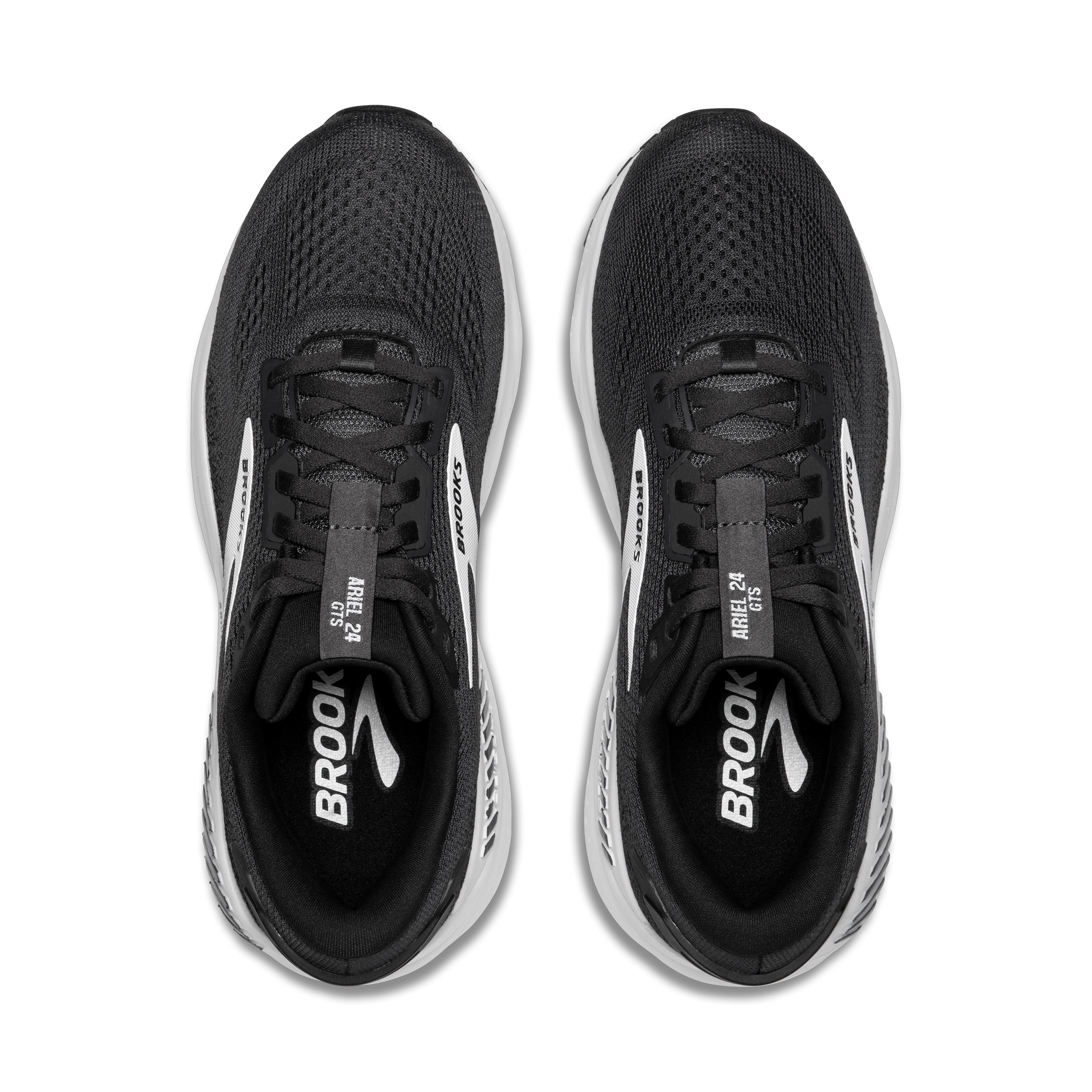Black running shoes with white soles and Brooks logo on a white background