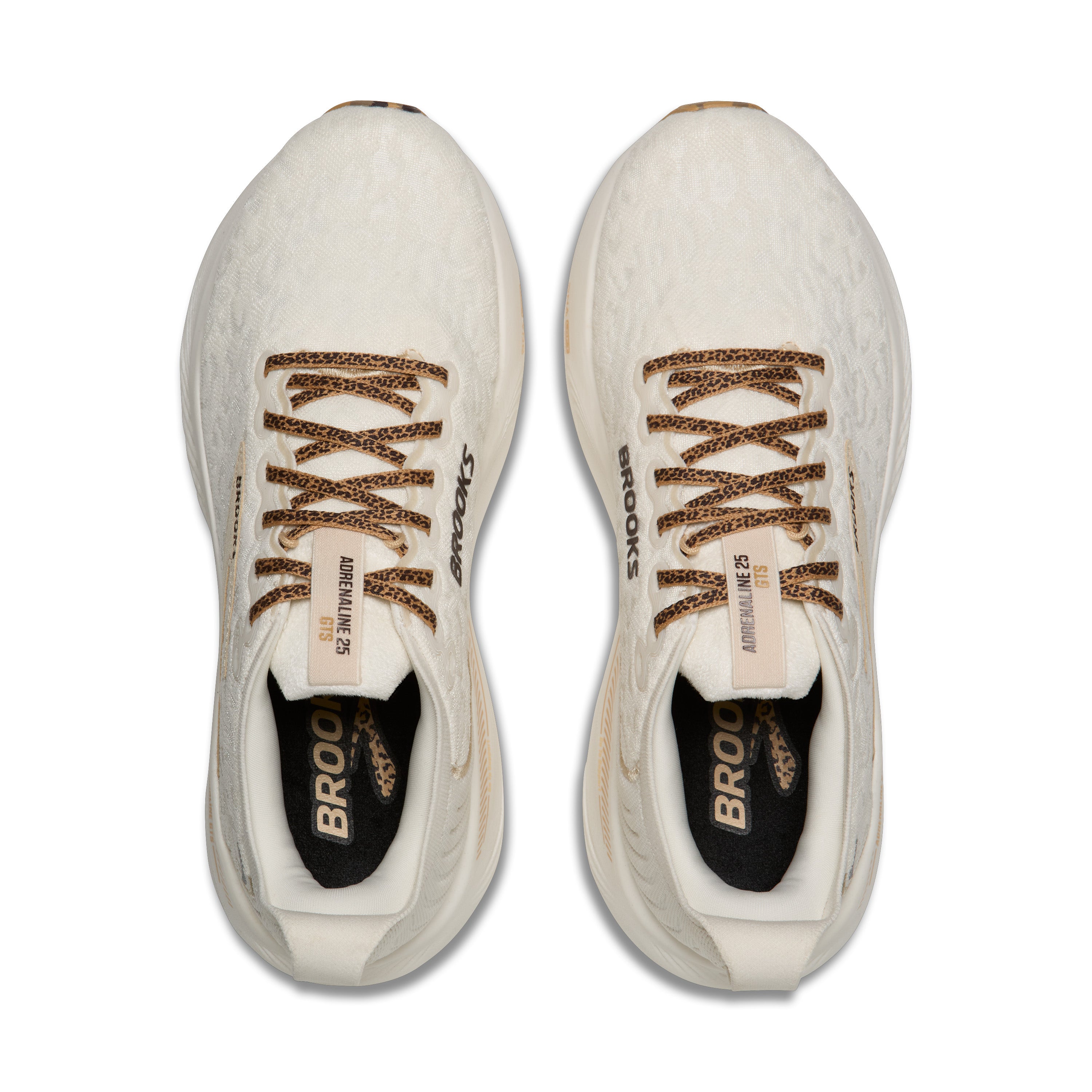 White running shoes with brown laces and 'Brooks' branding on a white background