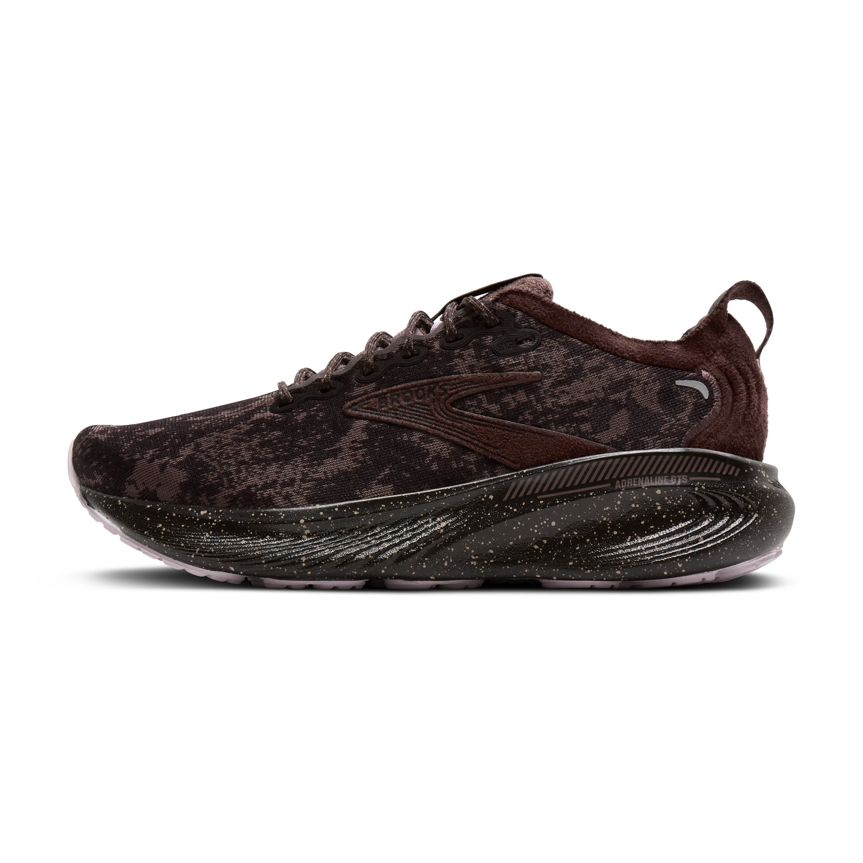 Brown running shoe with black sole on a white background