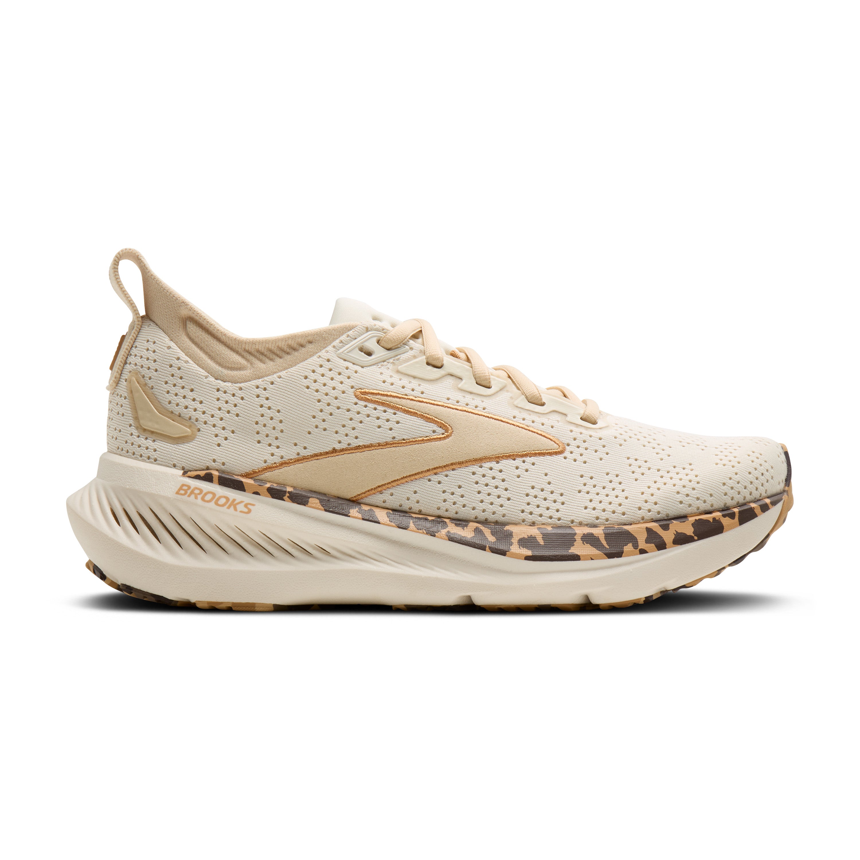 Beige running shoe with leopard print sole on a white background