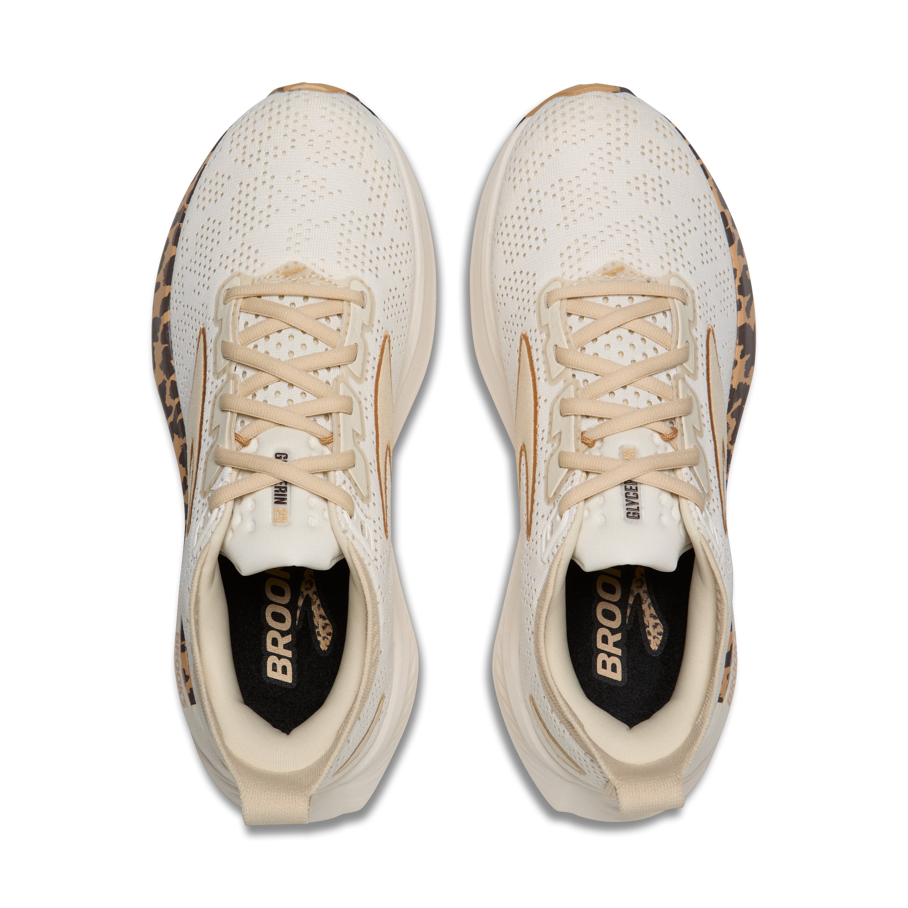 Pair of white running shoes with leopard print accents on a white background