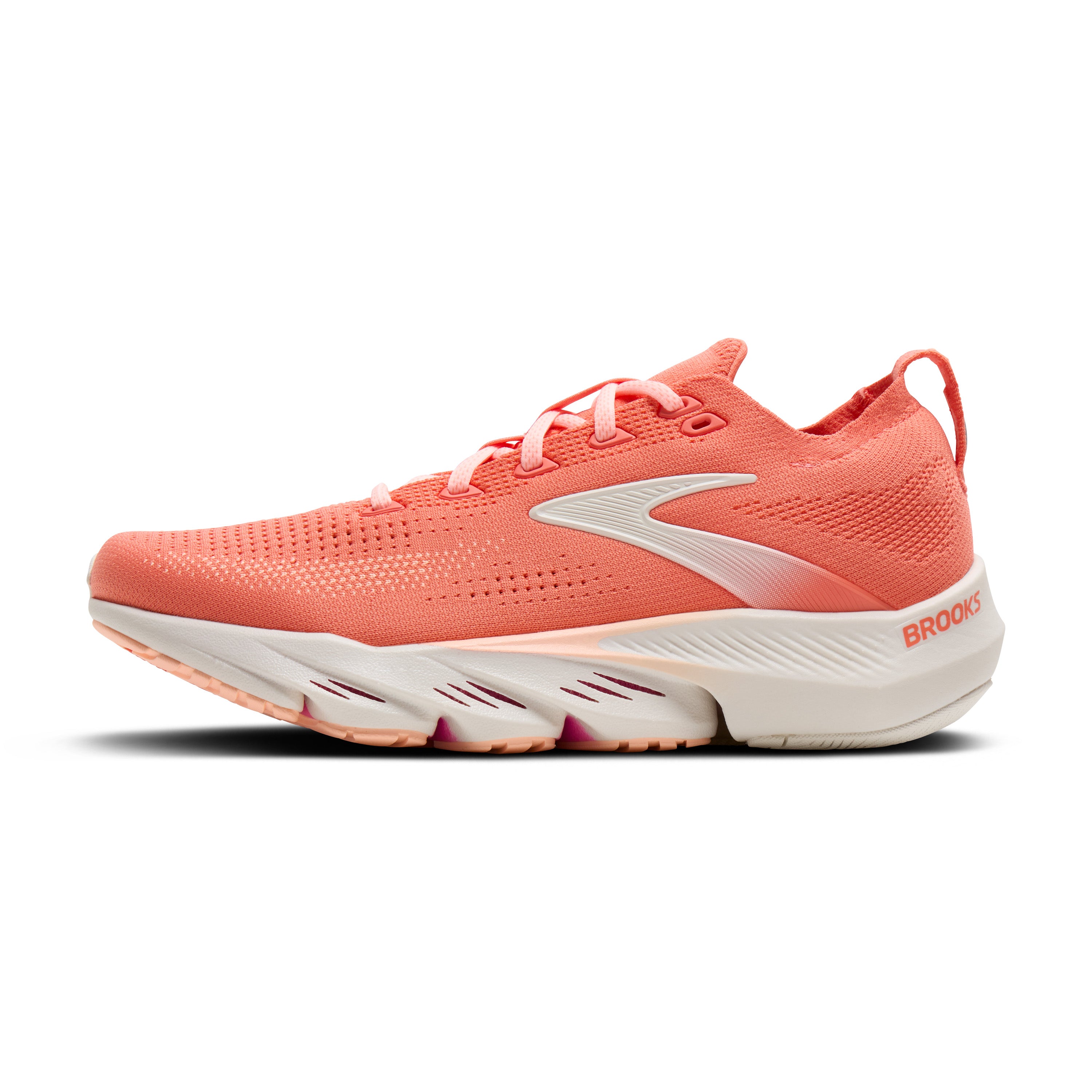 Coral running shoe with white sole on a white background