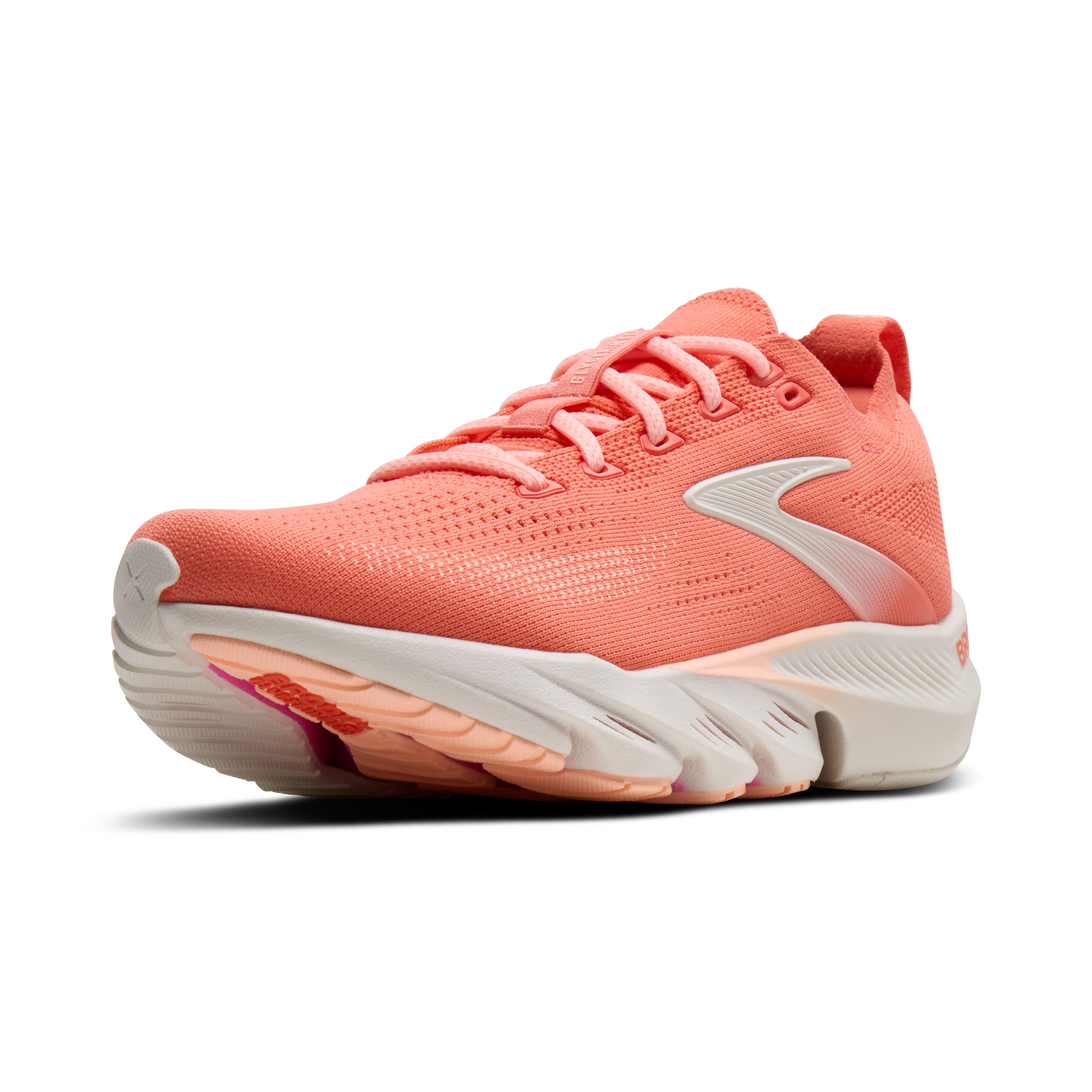 Coral running shoe with white sole on a white background