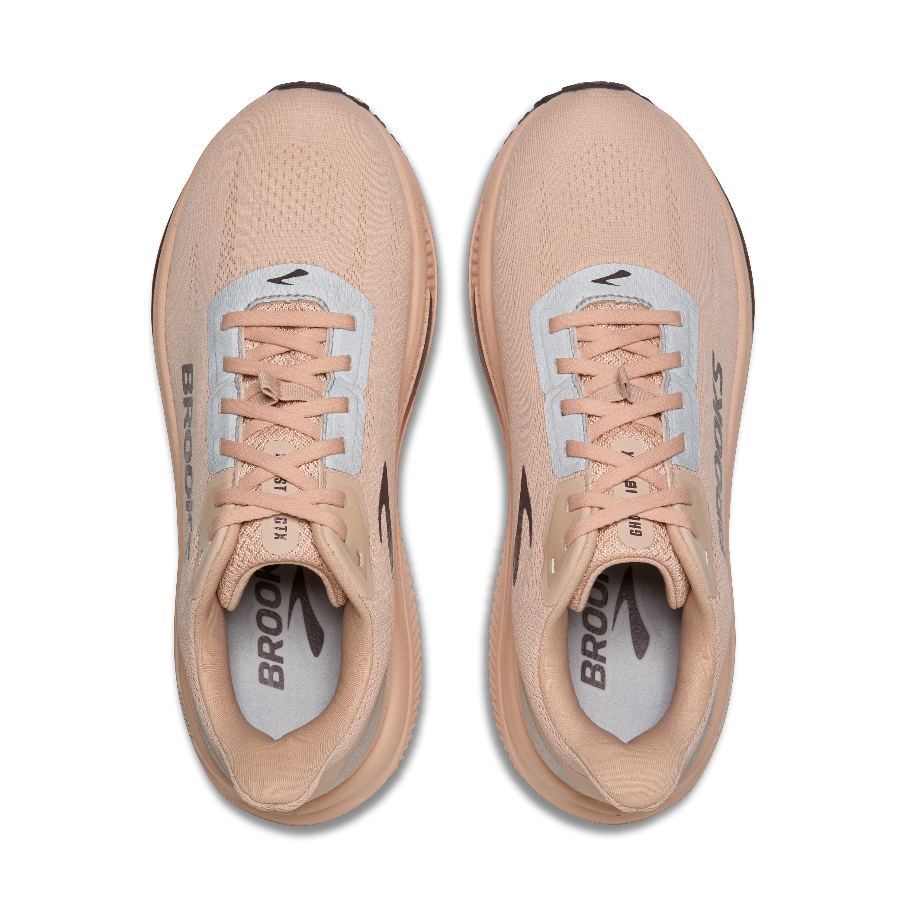 A pair of Brooks running shoes in a light peach-beige color, shown from a top-down view on a white background.