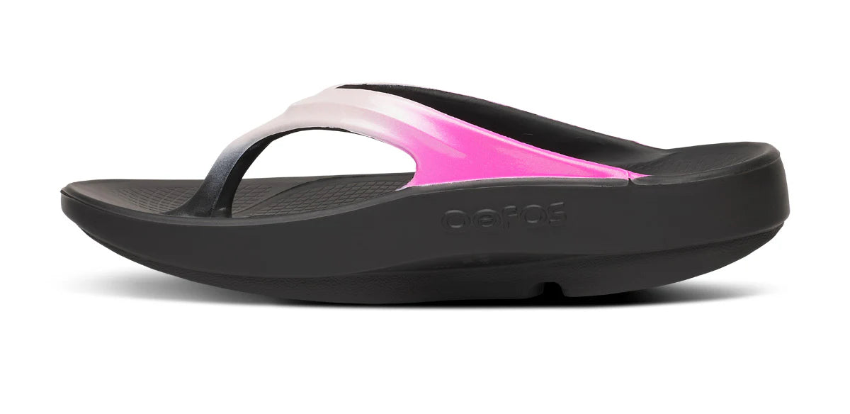 Black sandal with pink interior on a white background