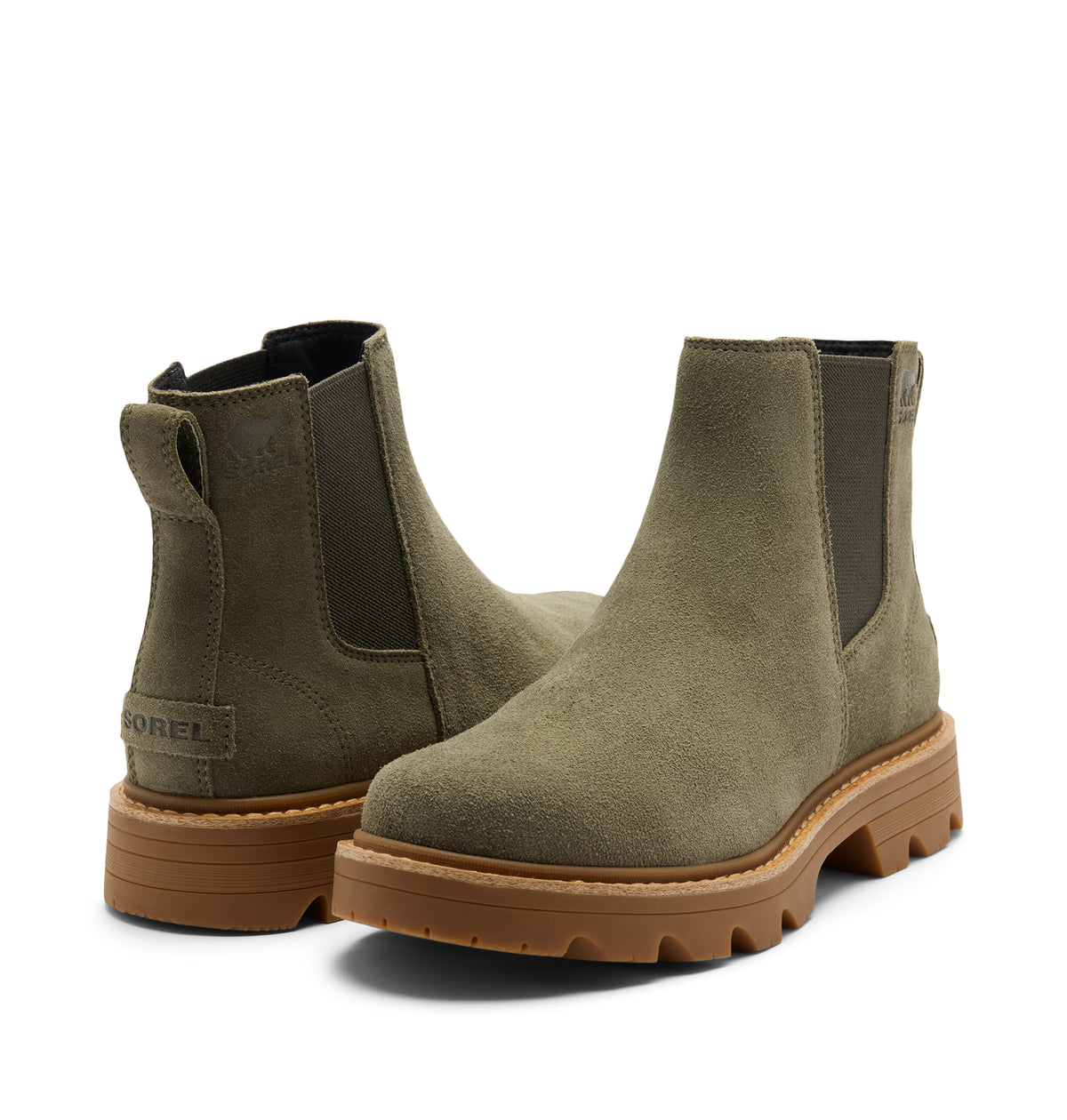 A pair of olive green suede Chelsea boots with dark elastic side panels and chunky brown lug soles, shown on a clean white background.