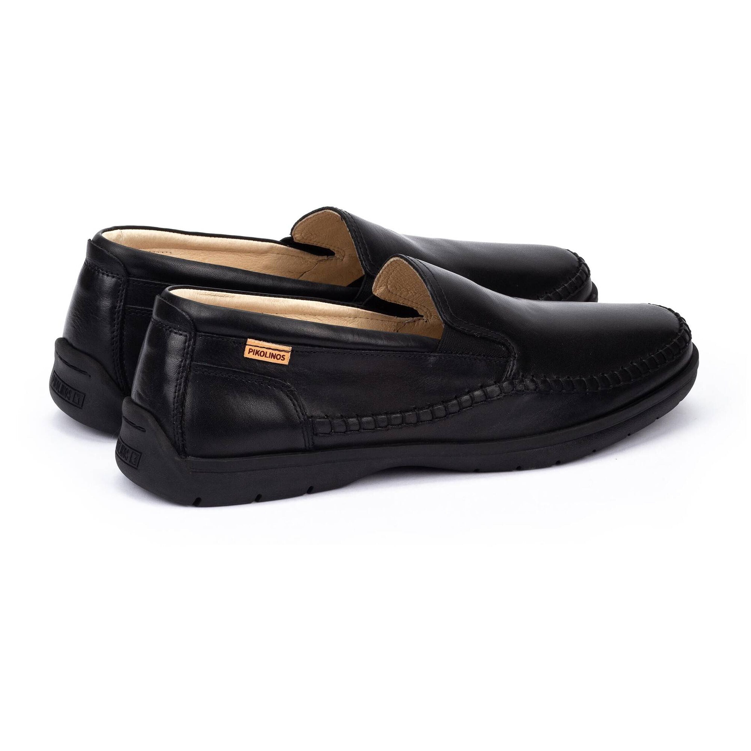 Pair of black loafers on a white background