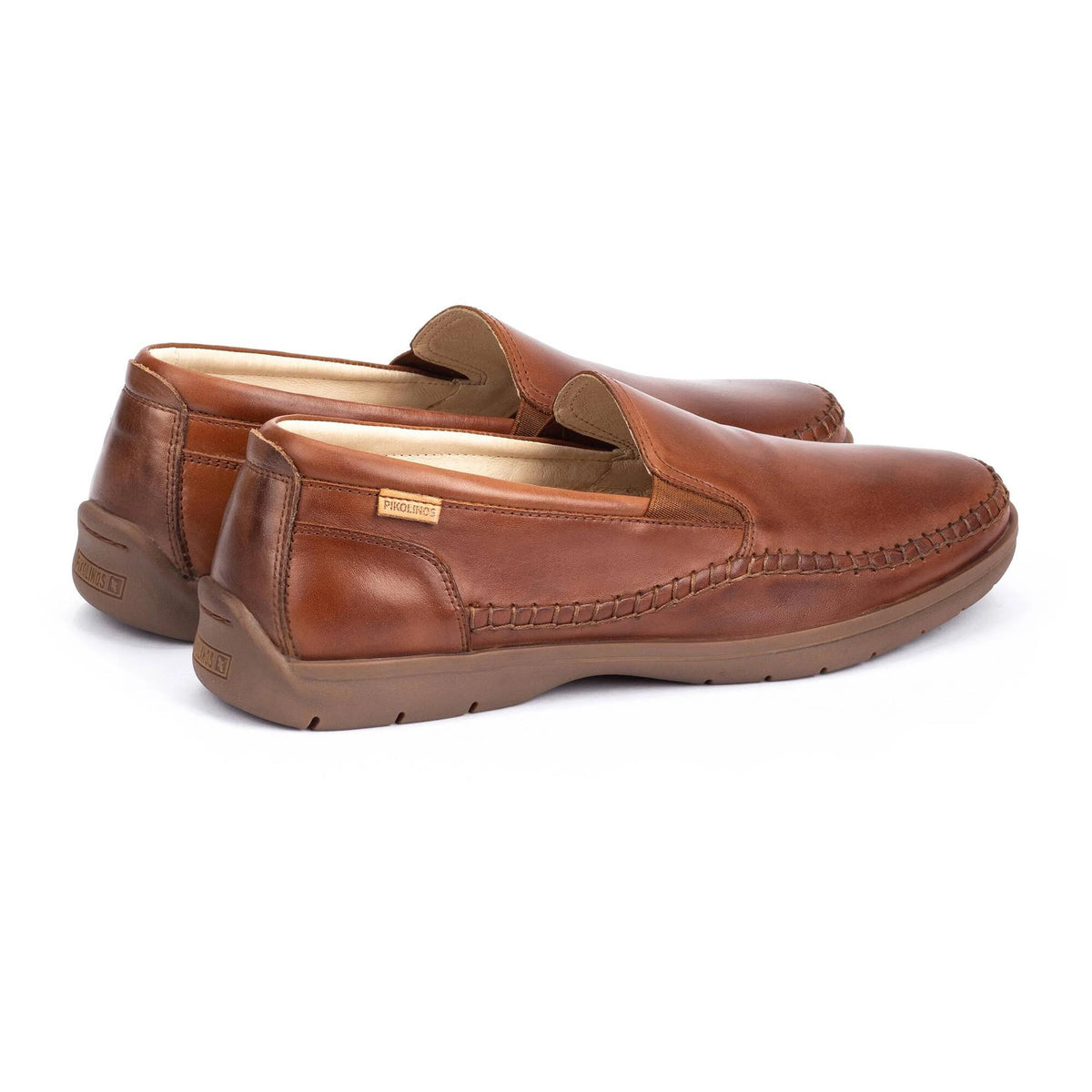 Pair of brown leather loafers on a white background