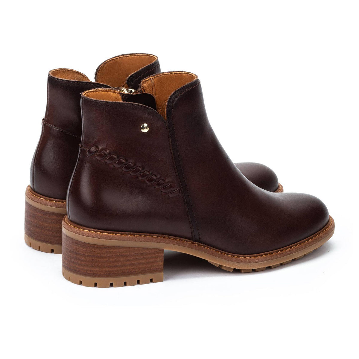 Pair of brown leather ankle boots on a white background