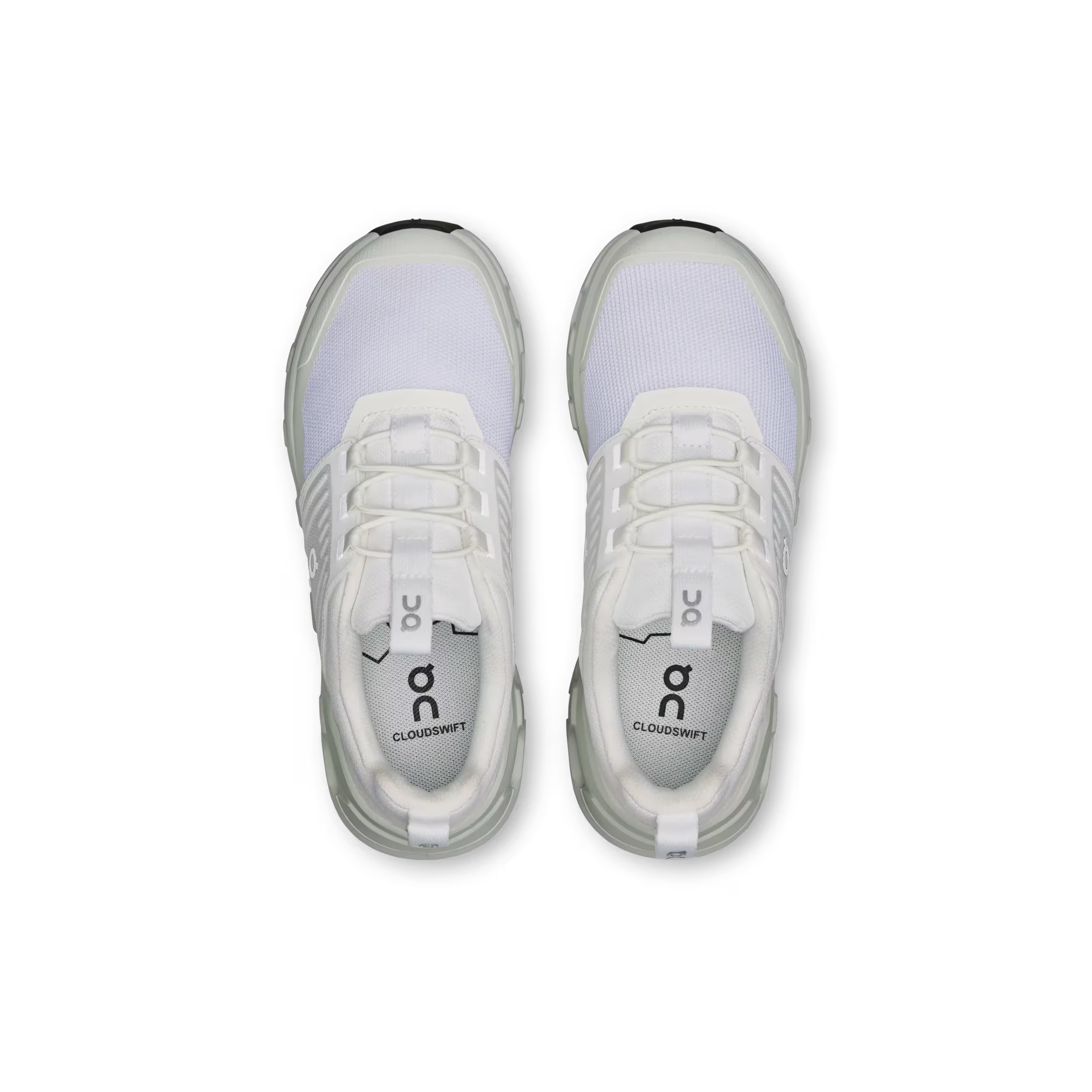 Pair of white athletic shoes with visible branding on a black background