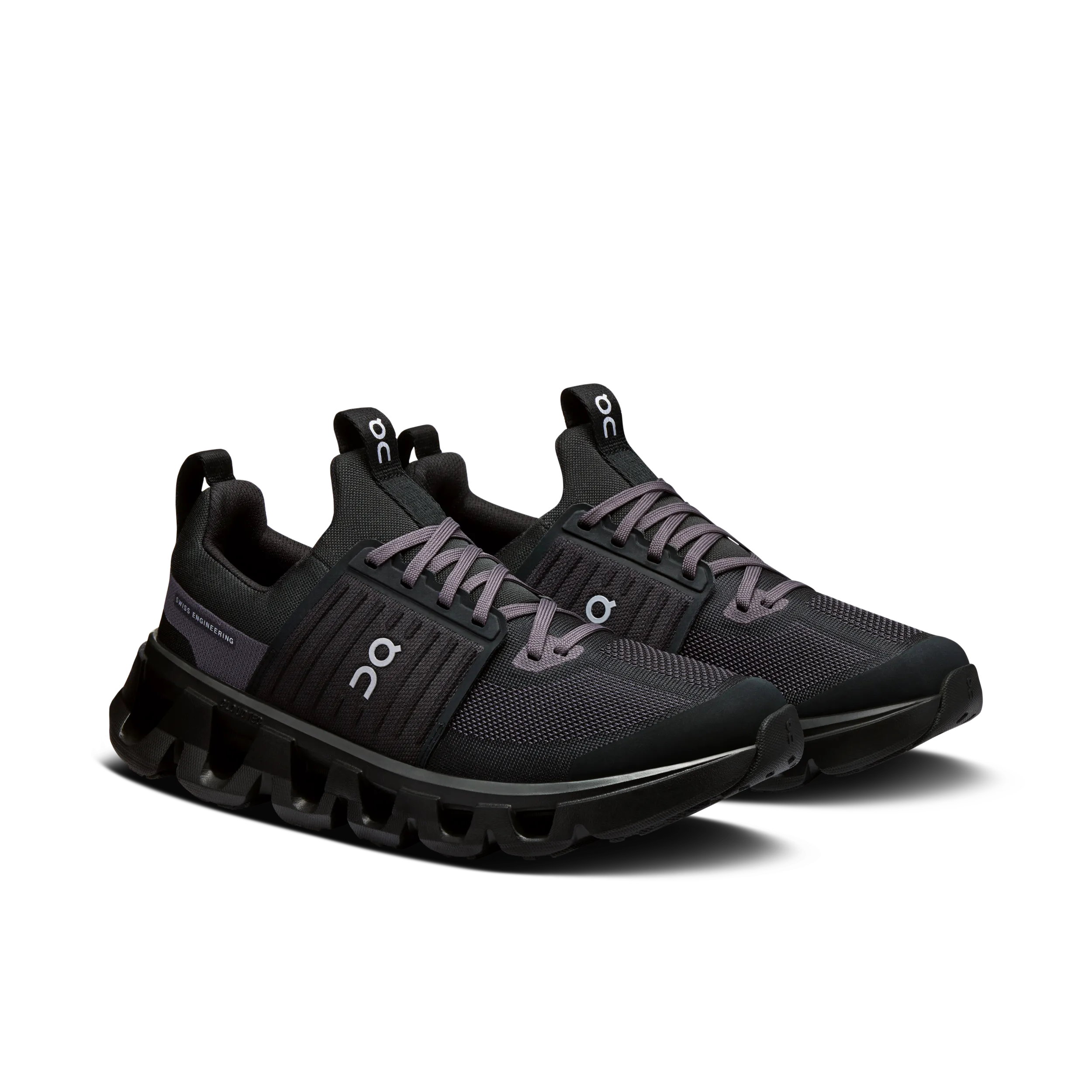 Black athletic shoes with unique sole design on a white background
