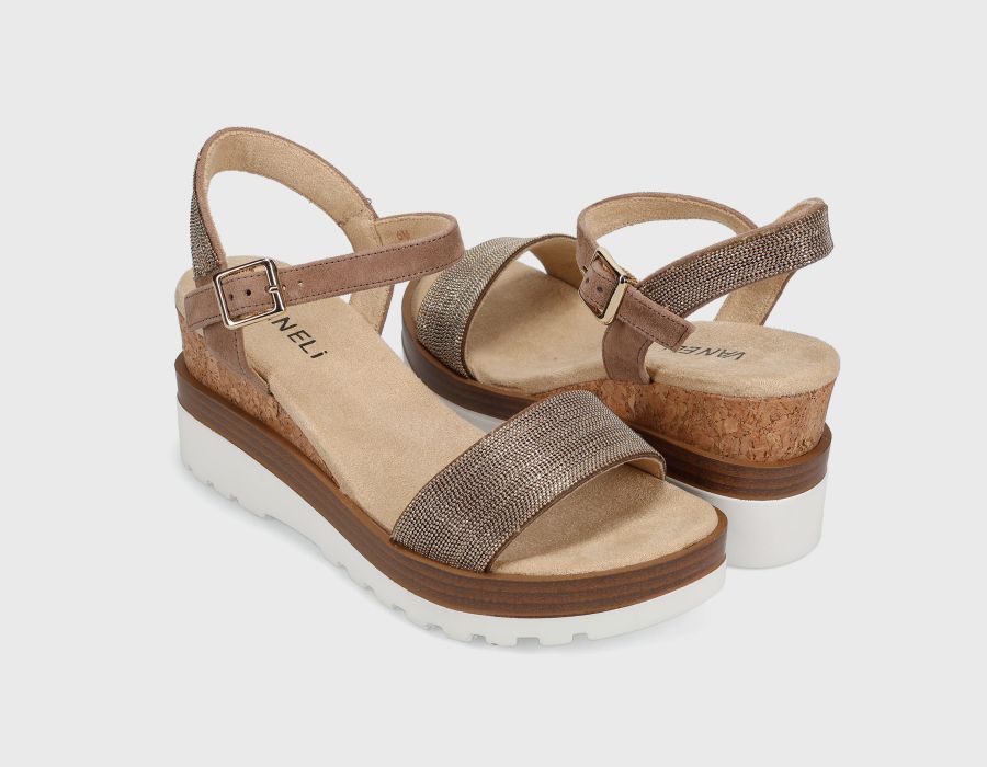 Pair of brown sandals with cork sole on a light gray background