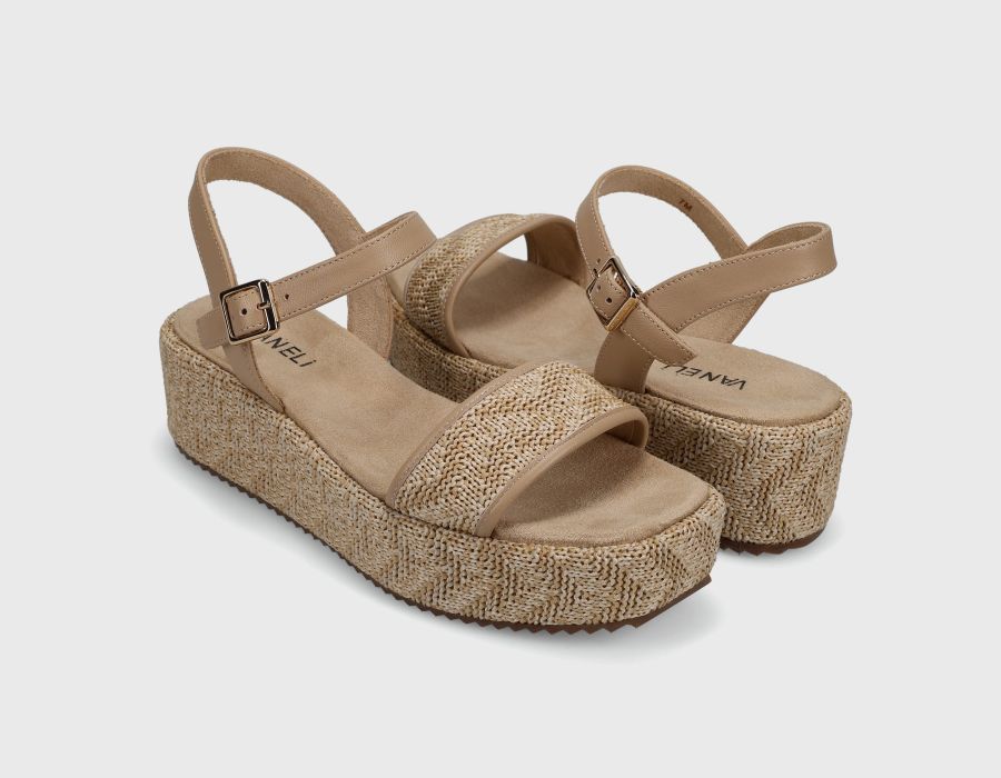 Pair of beige sandals with woven sole on a light gray background