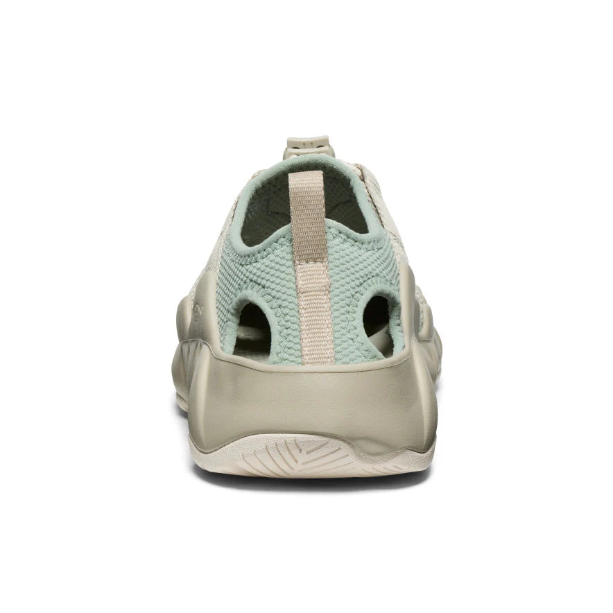 Light green sandal with a beige sole on a white background