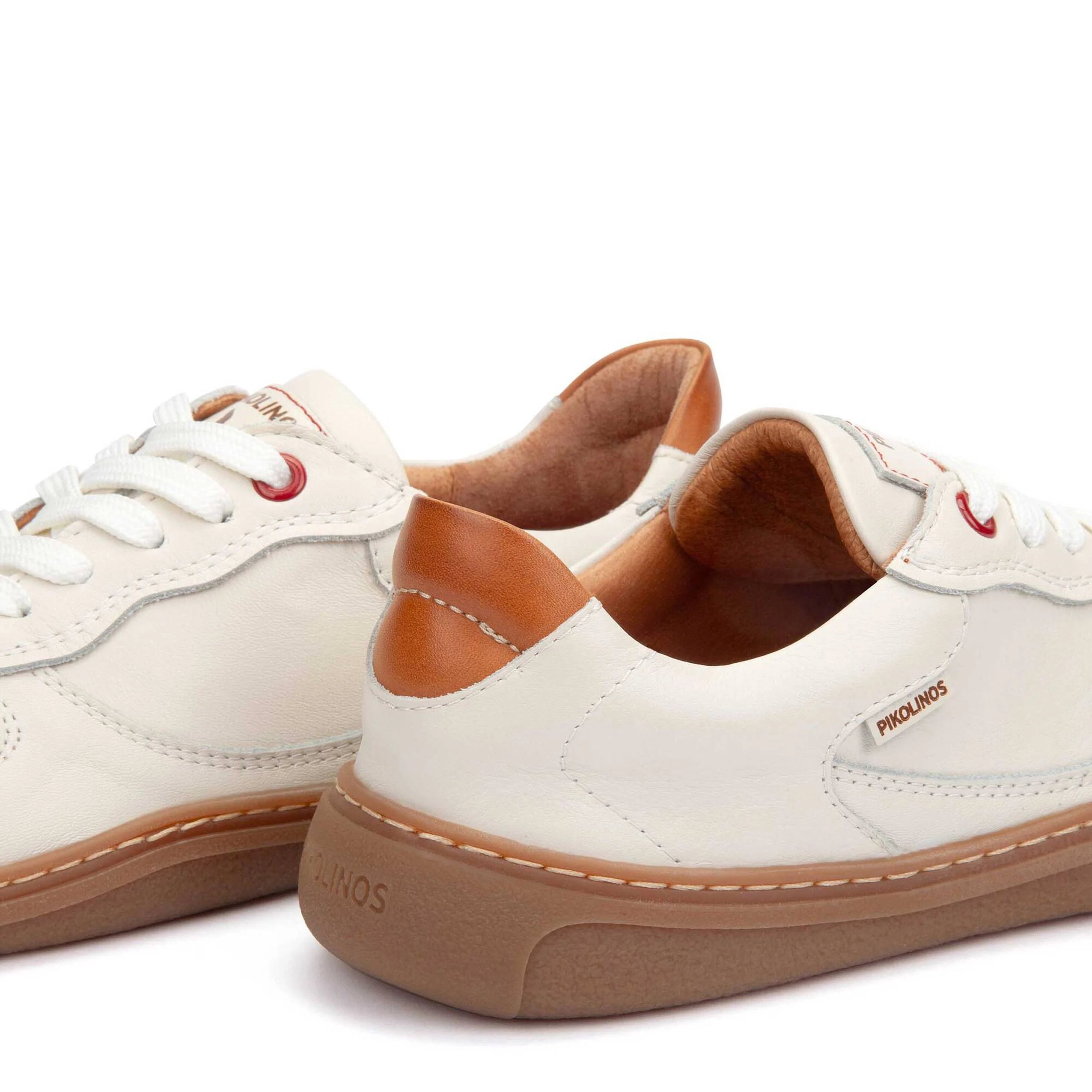 White sneakers with brown accents on a white background
